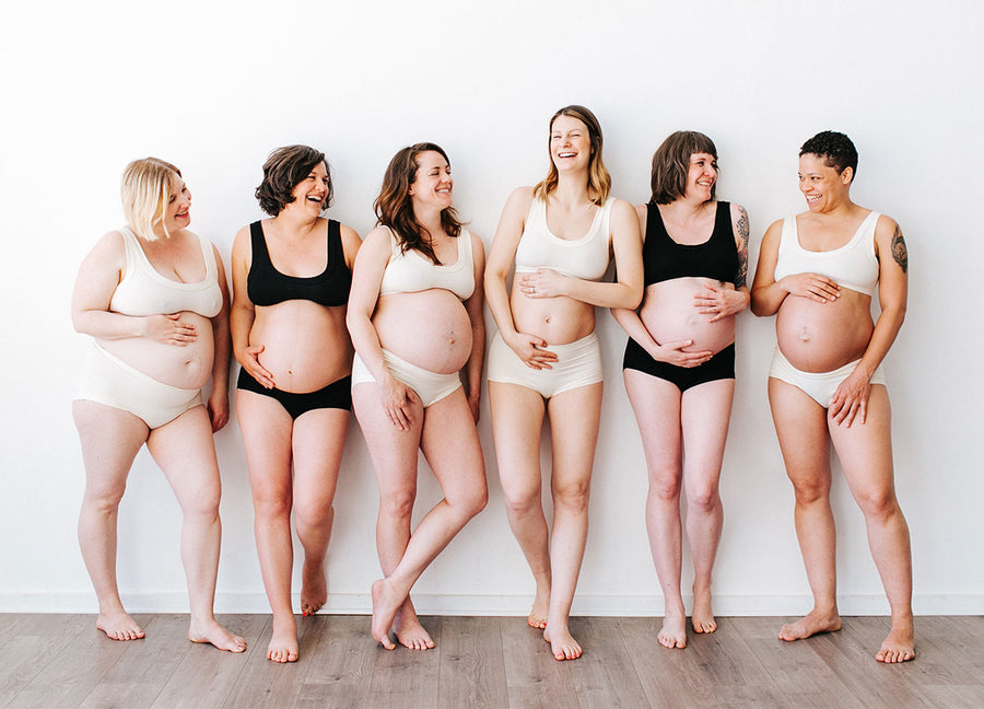 Group of six pregnant Women wearing Thunderpants Organic Cotton Original and Hipster underwear and Bralettes in both plain Vanilla and plain Black colors.