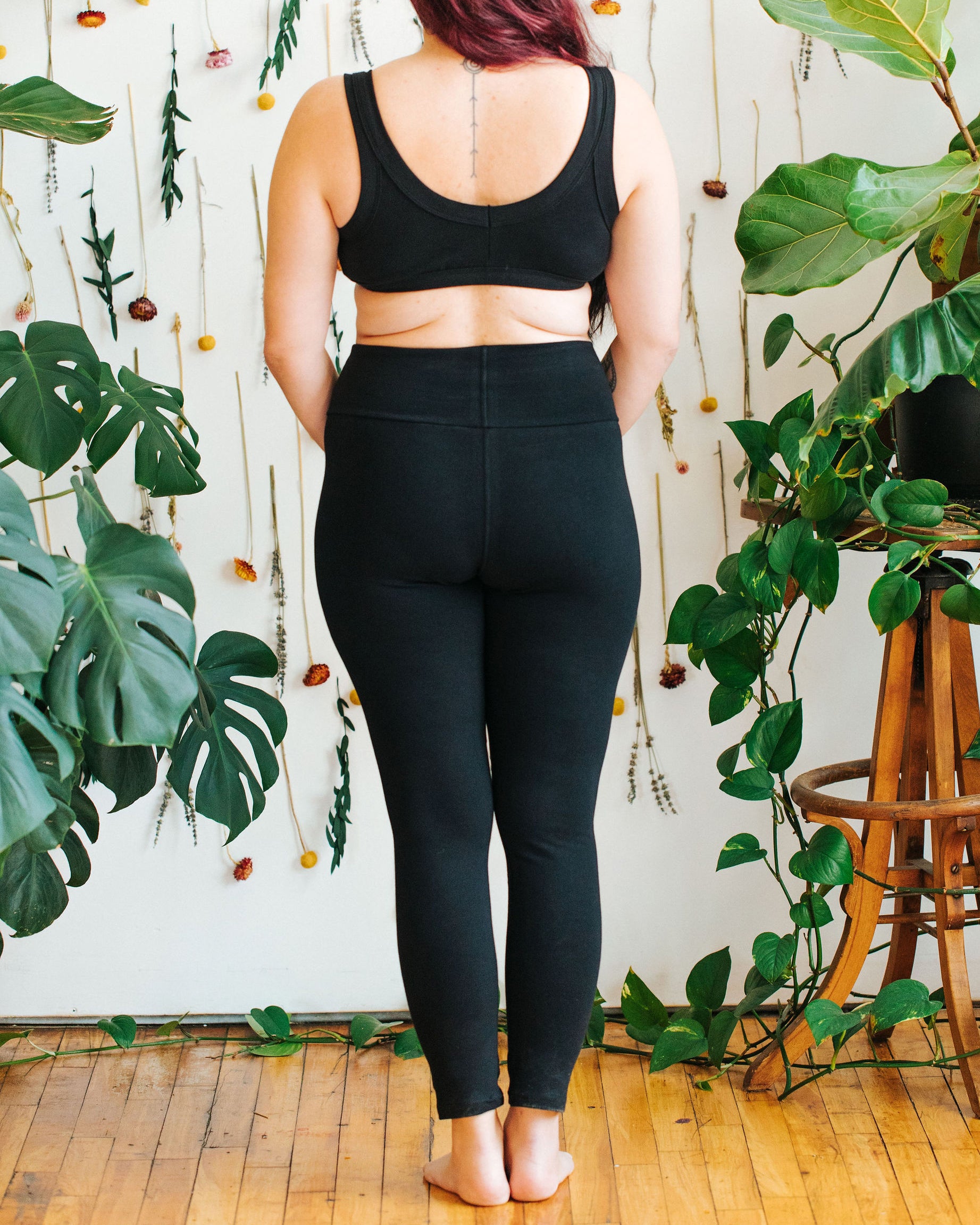 Close up image of model wearing Thunderpants Ankle Length Leggings in Plain Black. 