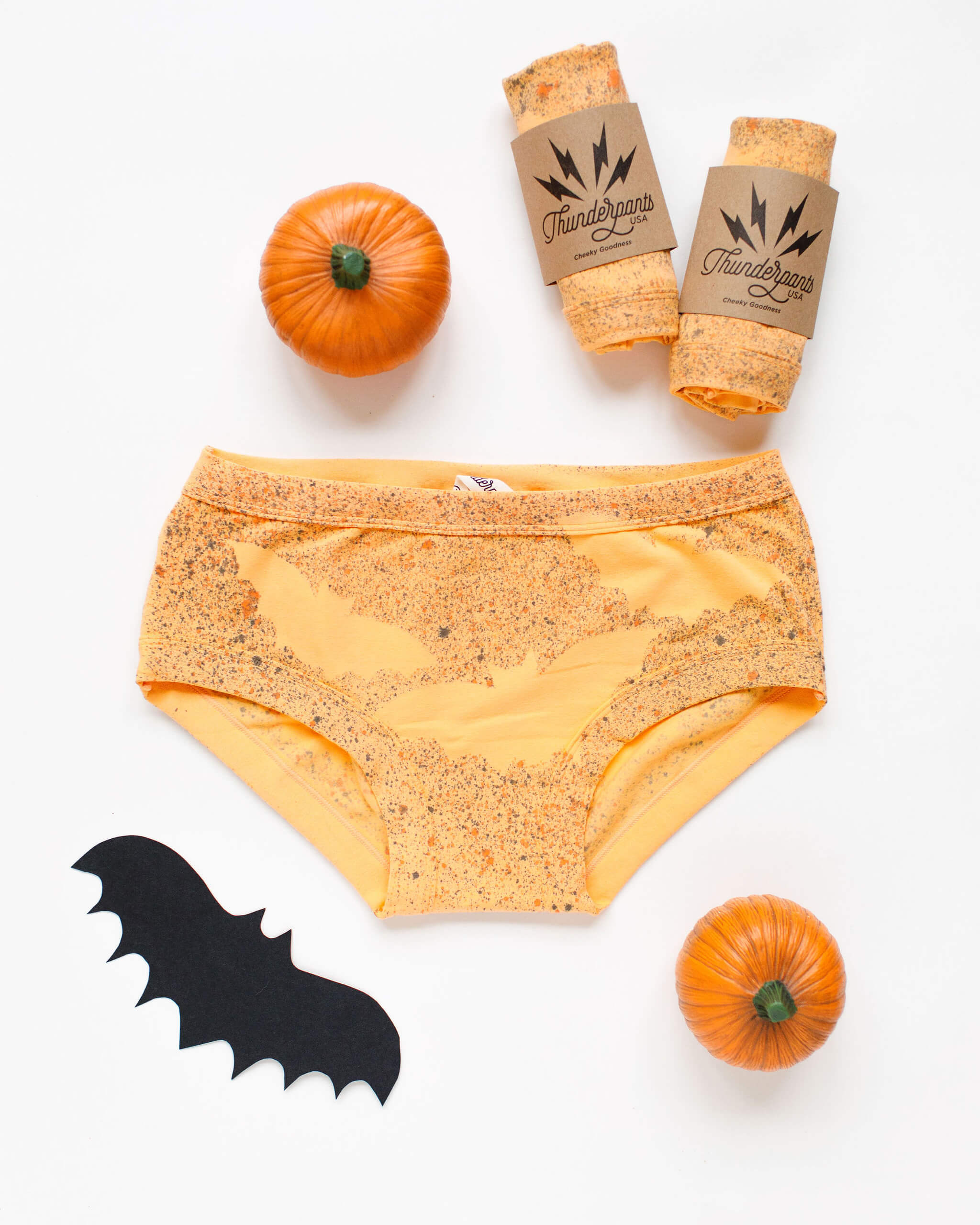 Flat lay of Thunderpants Hipster style underwear in Orange sherbet with bat dye.