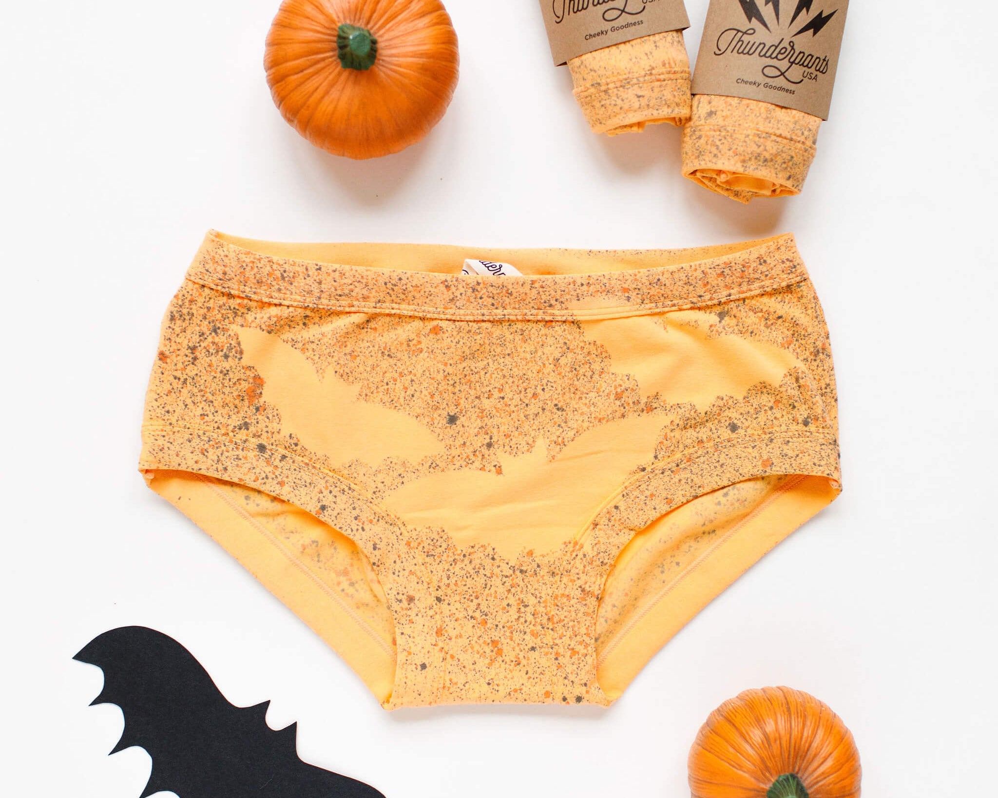 Flat lay of Thunderpants Hipster style underwear in Orange sherbet with bat dye.