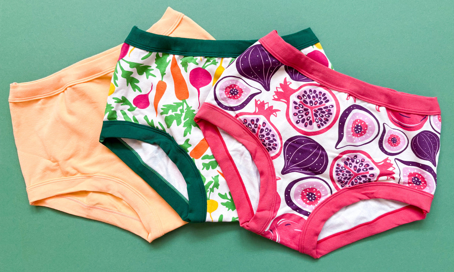 Flat lay of three Thunderpants Original style underwear in Two Fruits, Root Veggies, and Orange Sherbet.