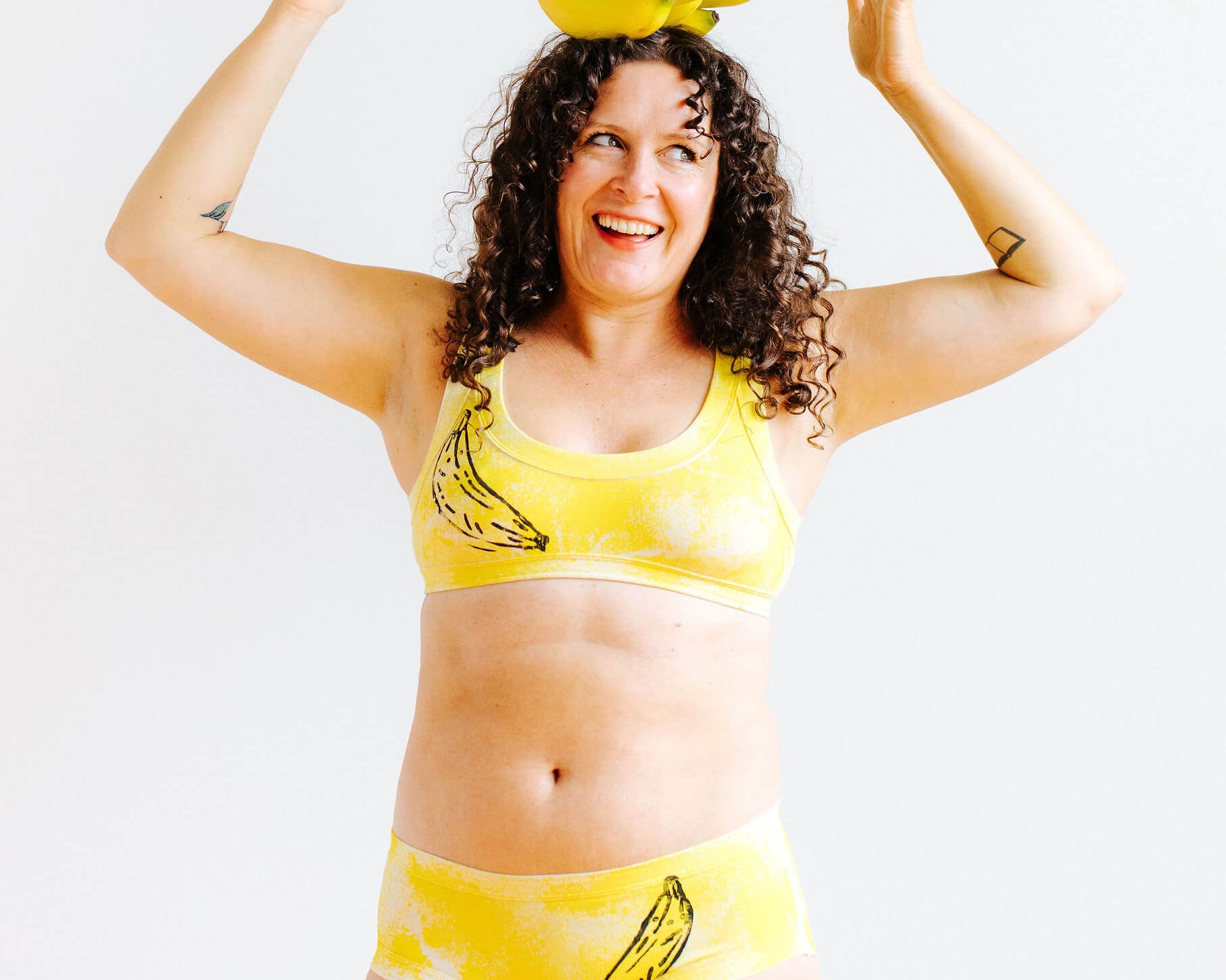 Model wearing Thunderpants Hipster style underwear and Bralette in Banana Pitch - yellow with one black banana print.