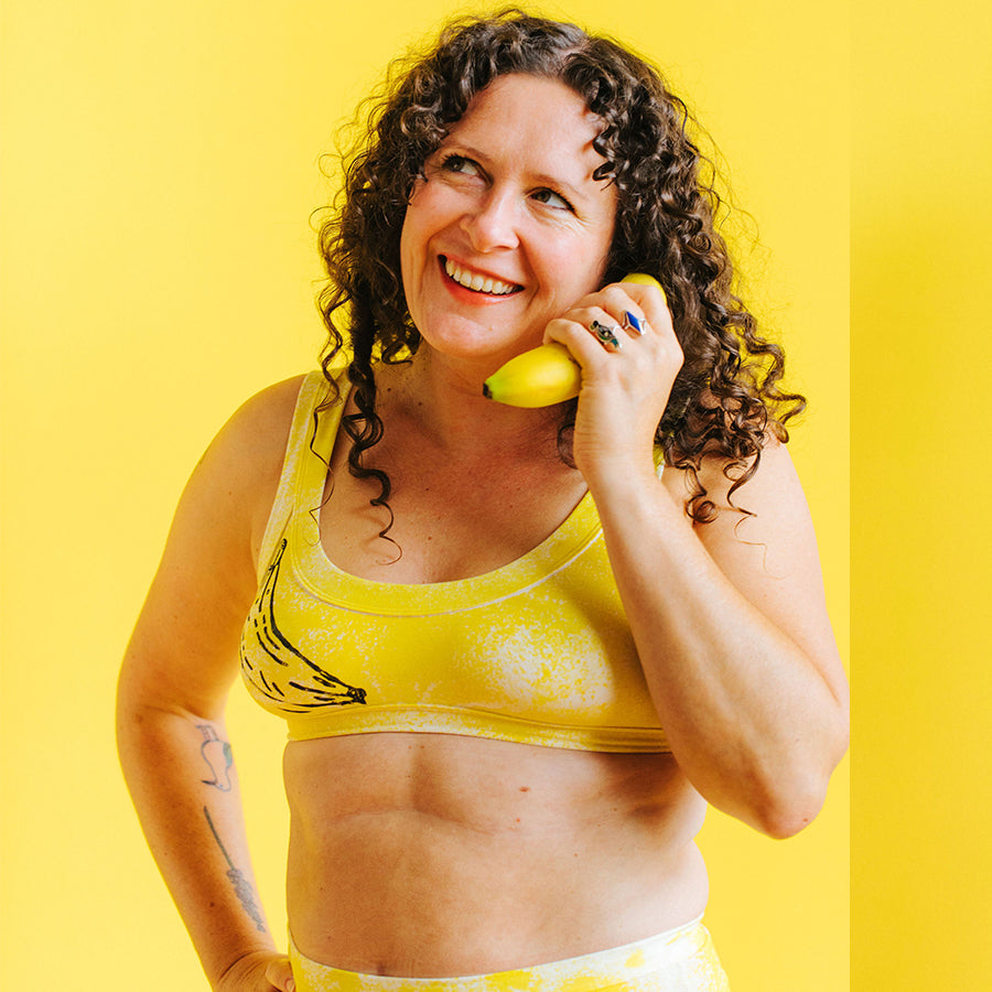 Model wearing Thunderpants Bralette and Sky Rise style underwear in Banana Pitch - yellow with black banana prints.