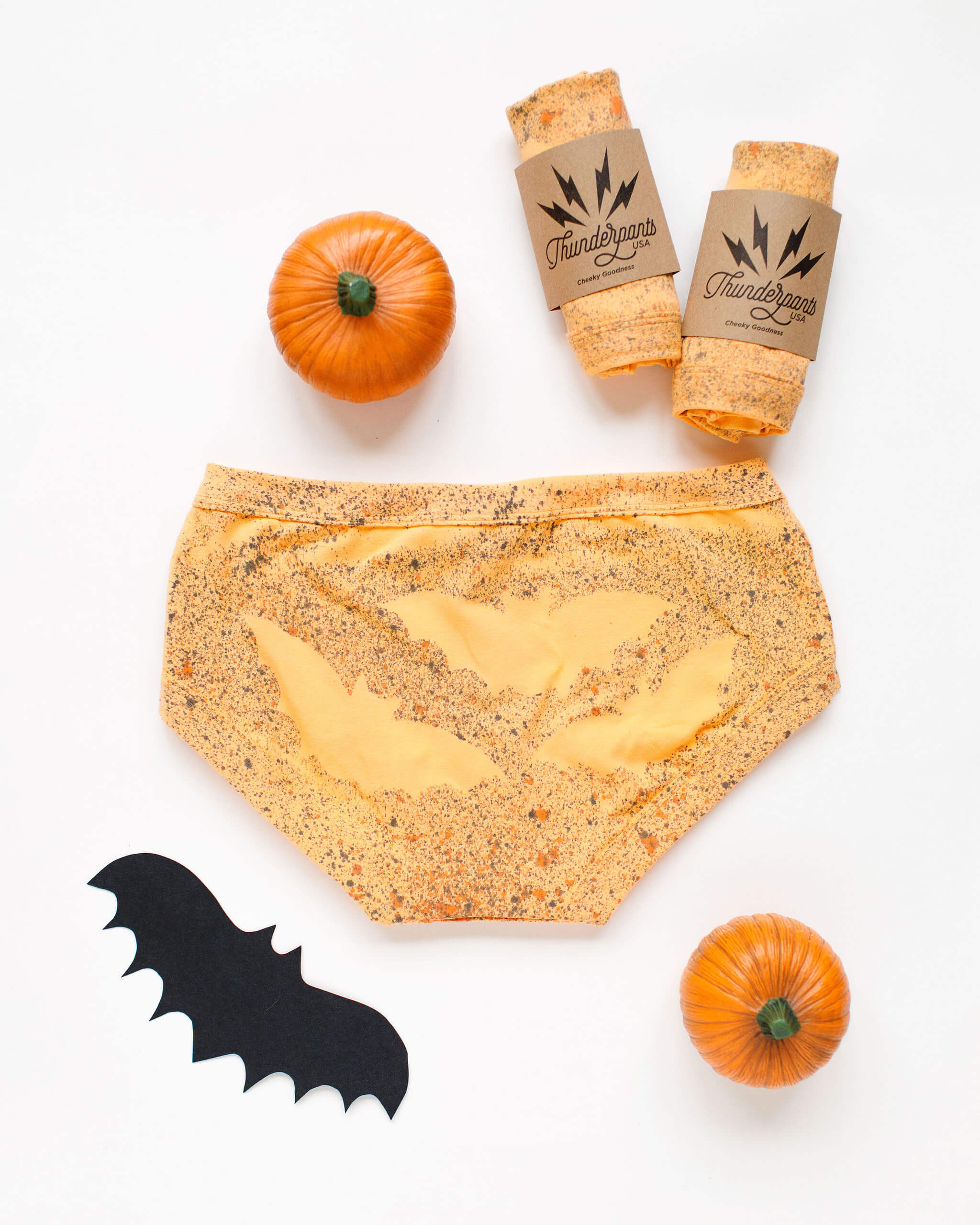 Flat lay of Thunderpants Hipster style underwear in Orange sherbet with bat dye.