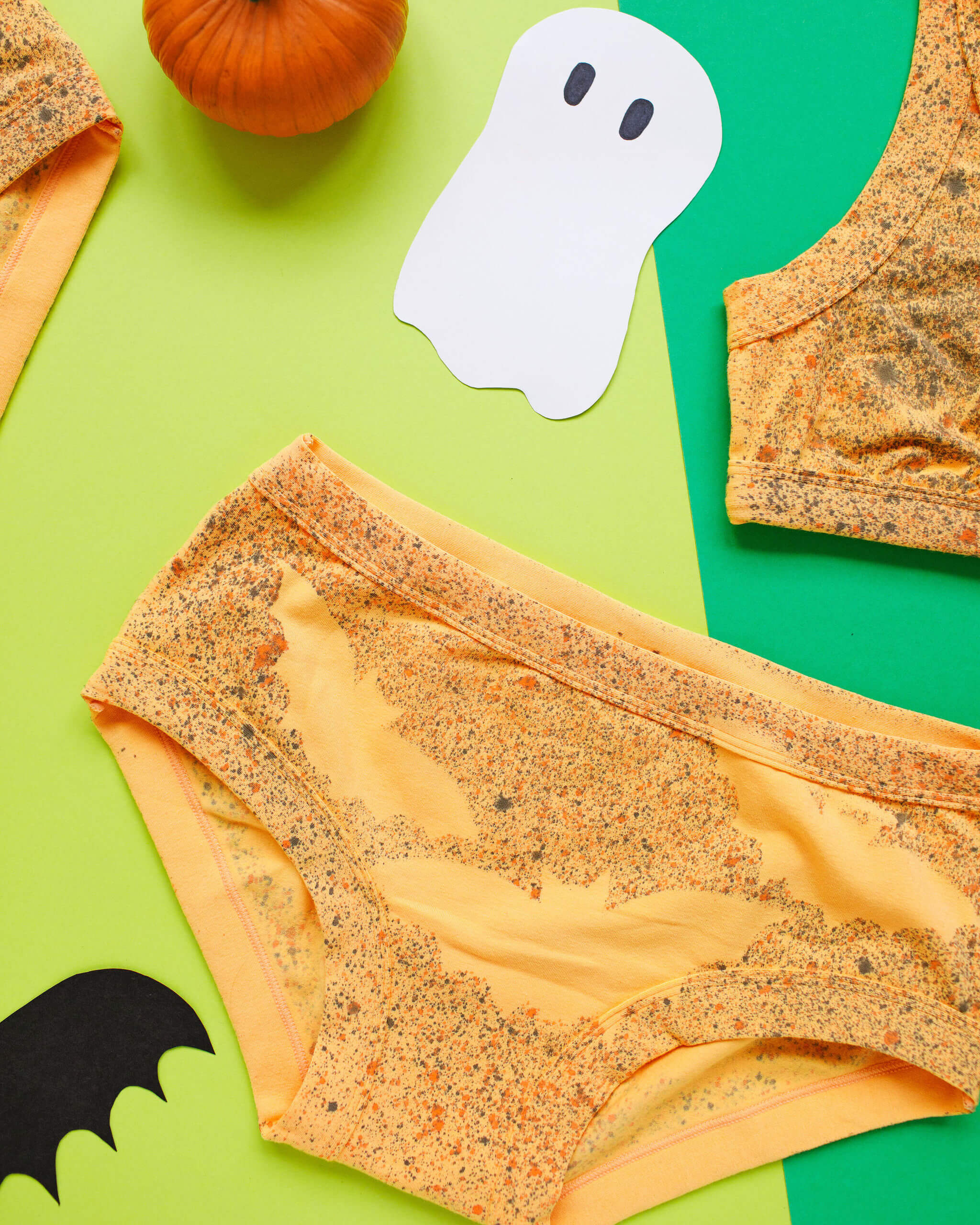 Flat lay of Thunderpants Hipster style underwear in Orange sherbet with bat dye.