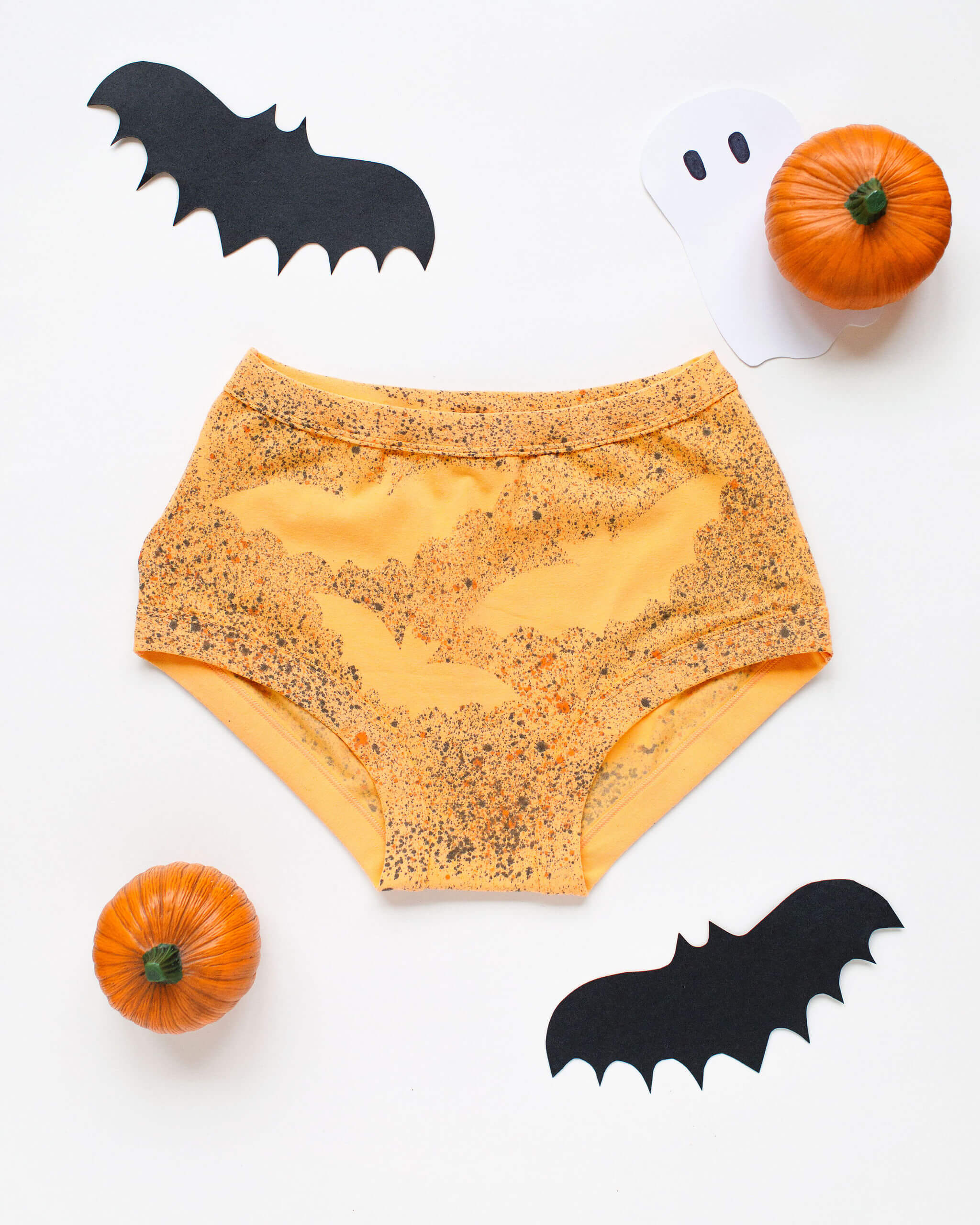 Flat lay of Thunderpants Original style underwear in Orange Sherbet with bat hand dye.