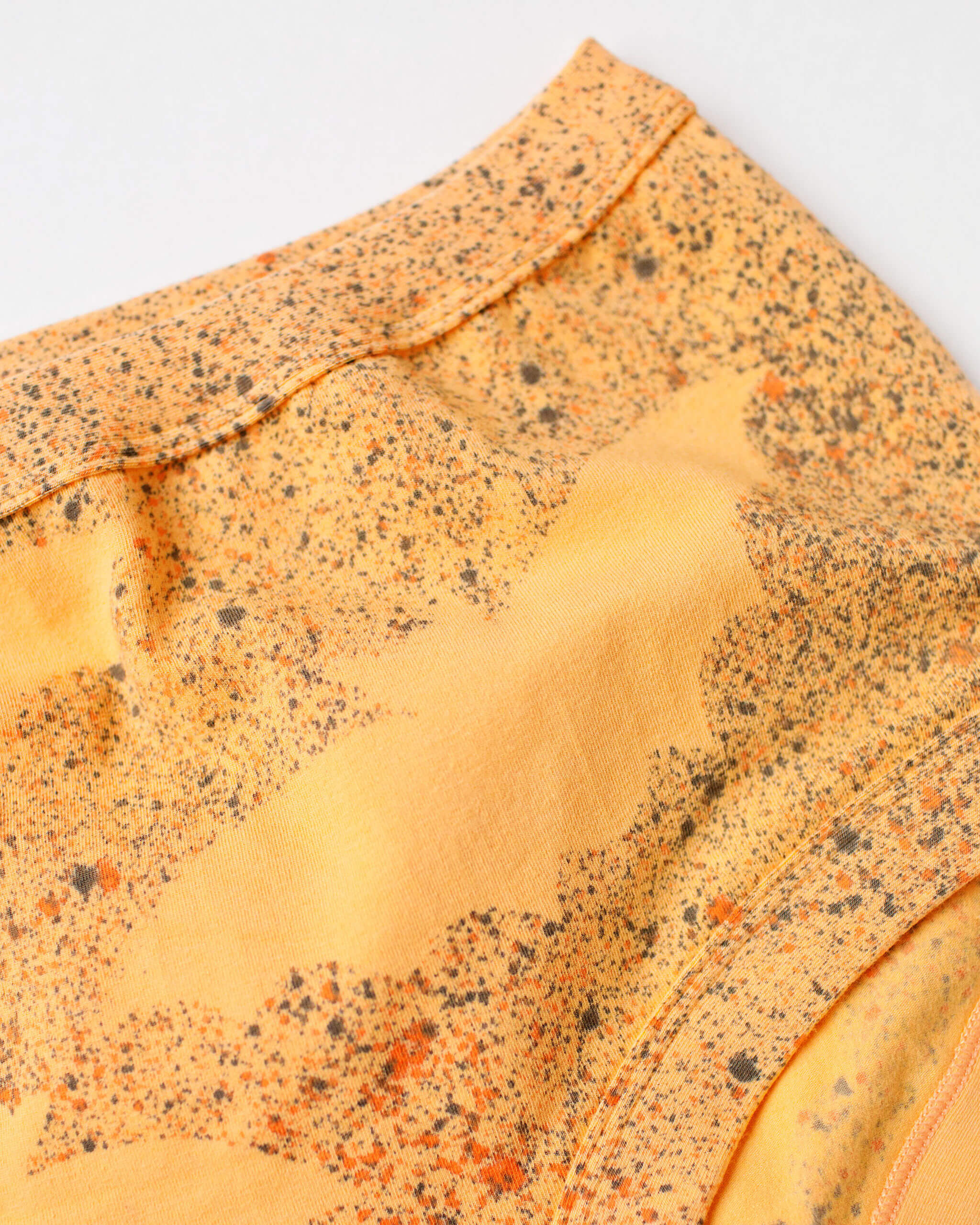 Flat lay of Thunderpants Original style underwear in Orange Sherbet with bat hand dye.