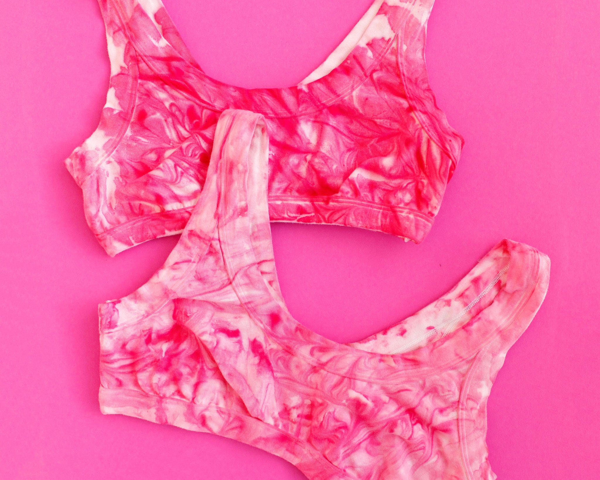 Two Thunderpants Bralettes in pink marble dye.