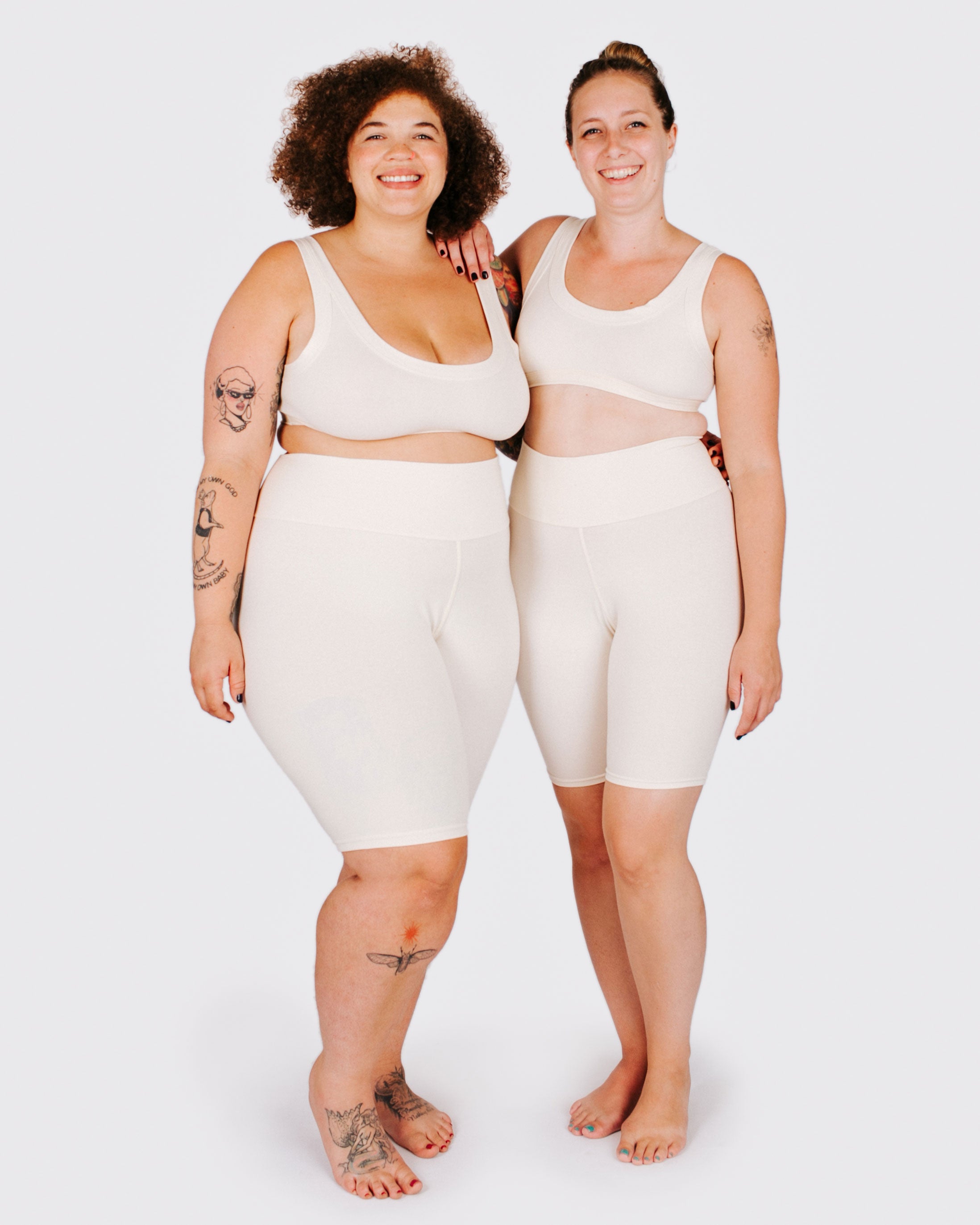 Fit photo from the front of Thunderpants organic cotton Bike Shorts and Bralettes in off-white on two model standing together.