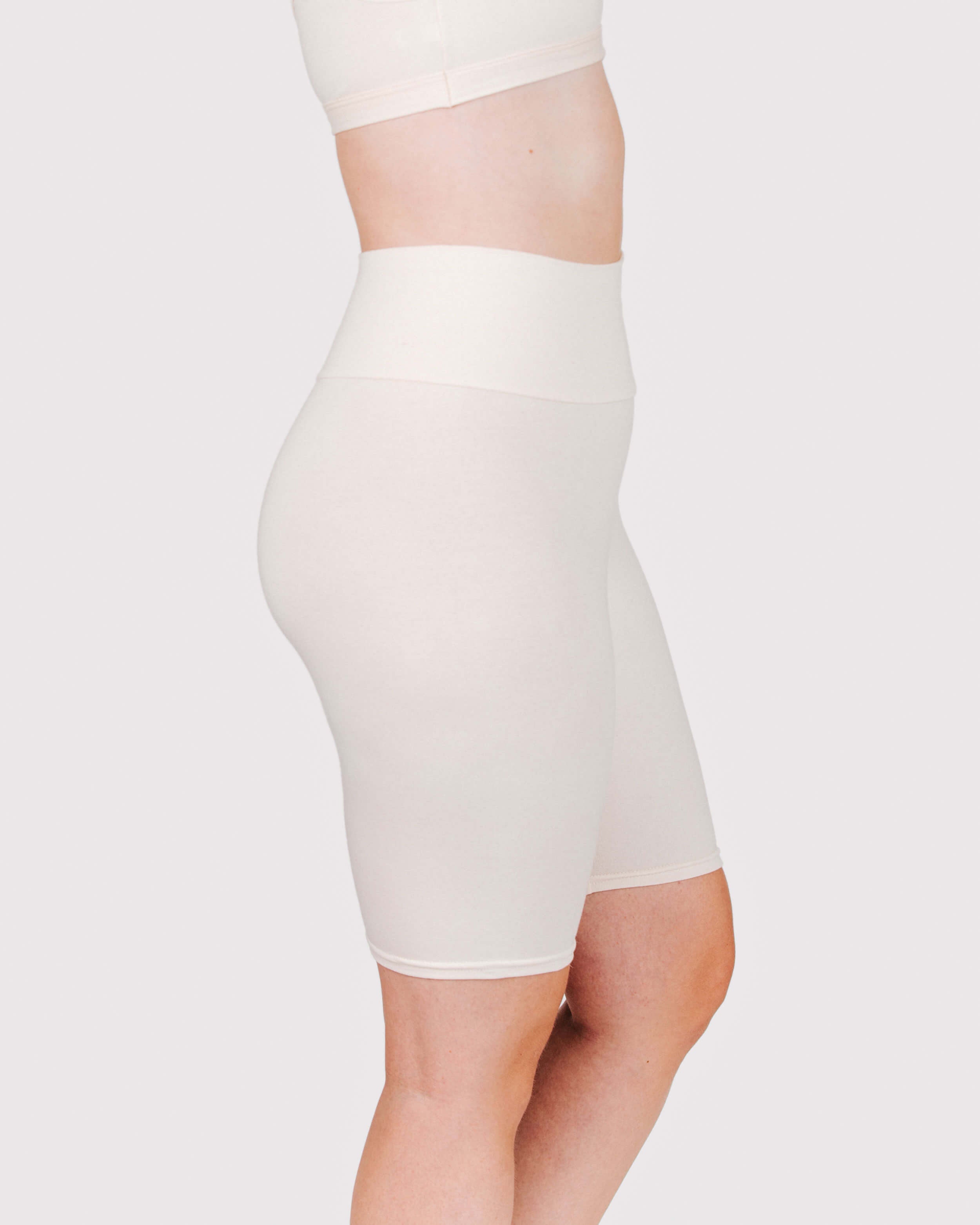 Fit photo from the side of Thunderpants organic cotton Bike Shorts in off-white on a model.