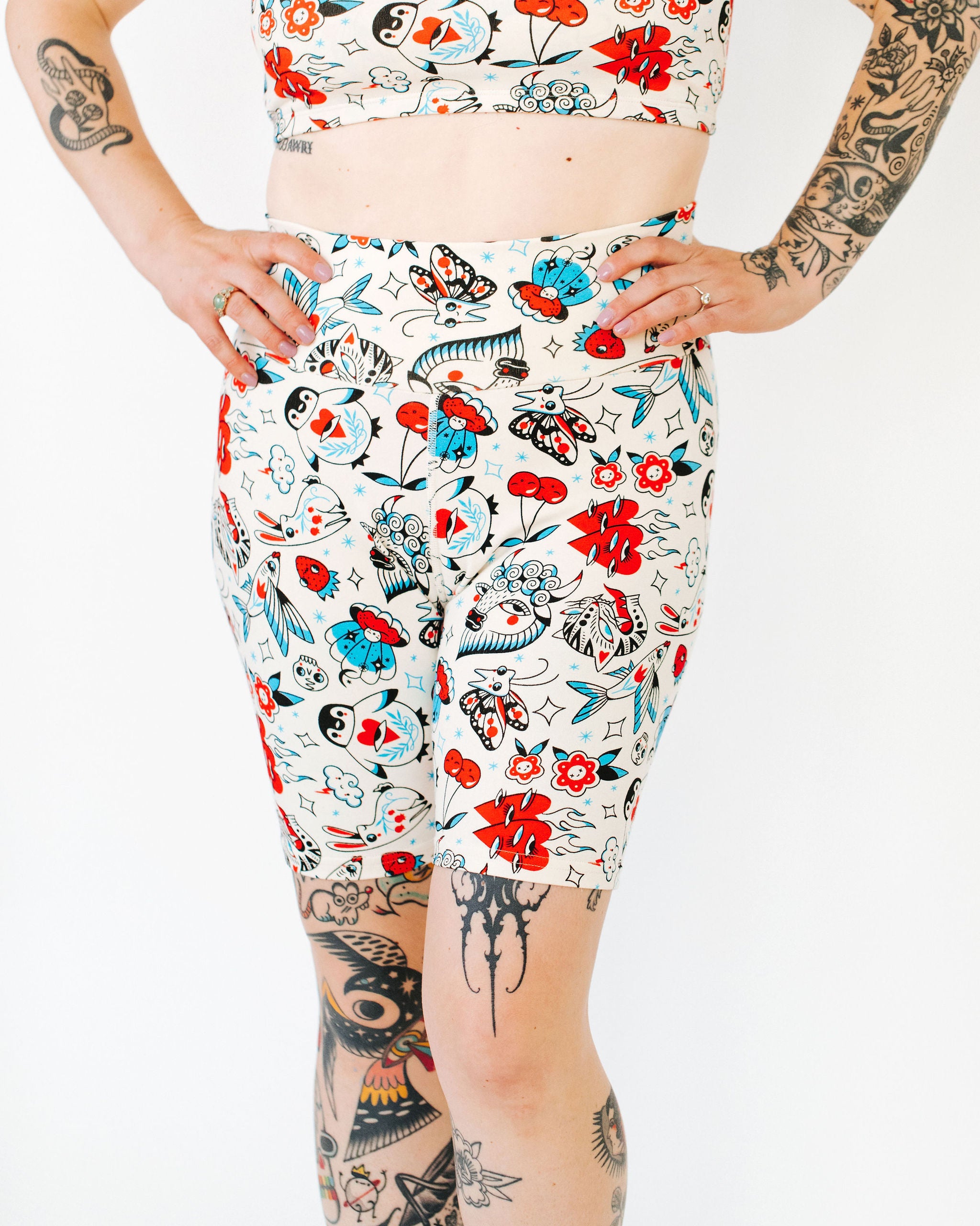 Model wearing Thunderpants Bike Shorts and Longline Bra in Inked Up - a tattoo pattern with black, red, and blue. 