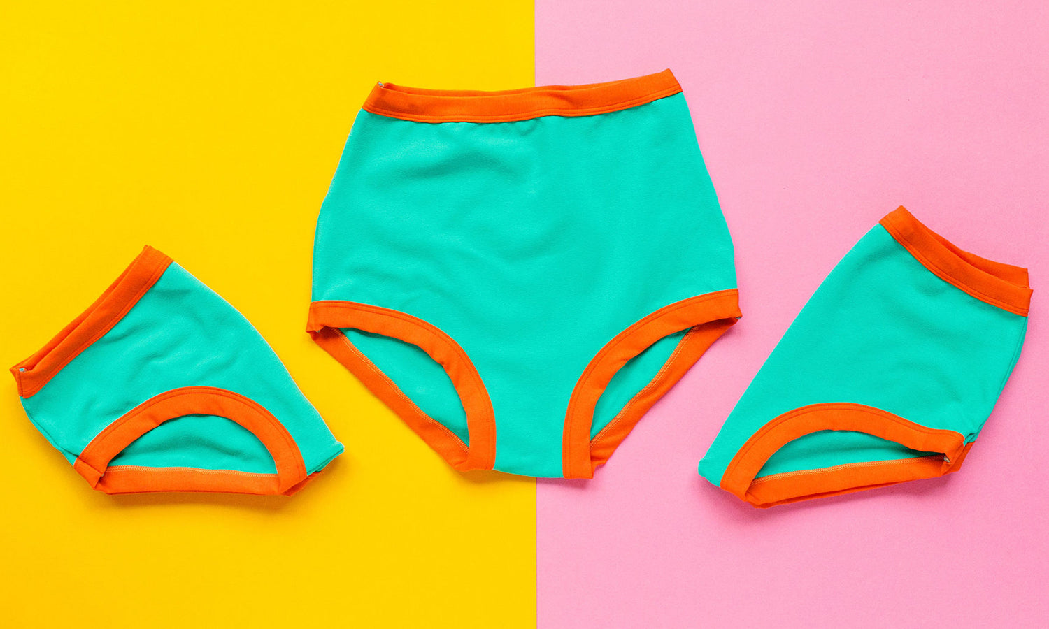 Three pairs of Thunderpants underwear in Bird in Paradise - Peacock Green and orange binding.
