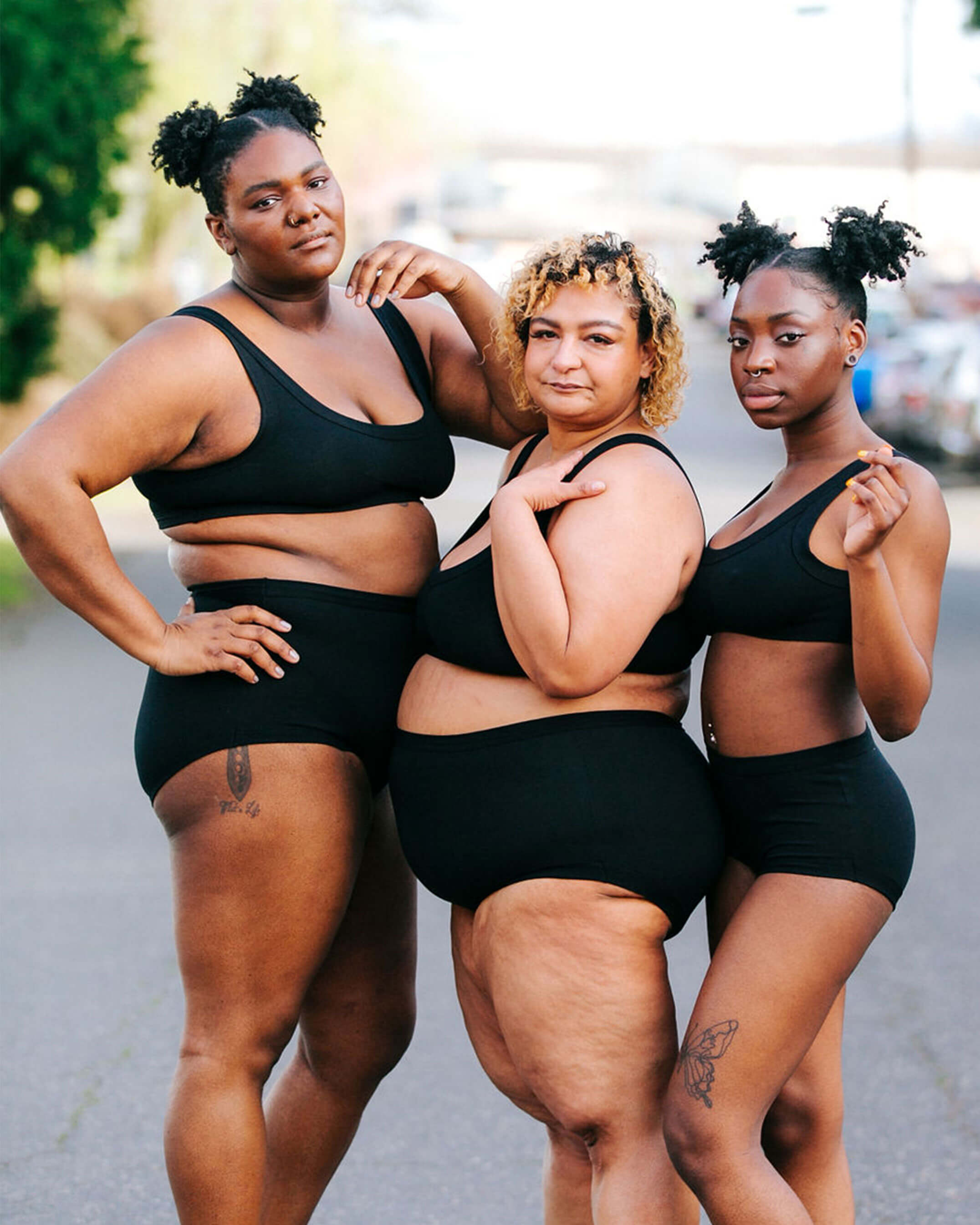 Three models wearing sets of Thunderpants Original style underwear and Bralettes in Plain Black.