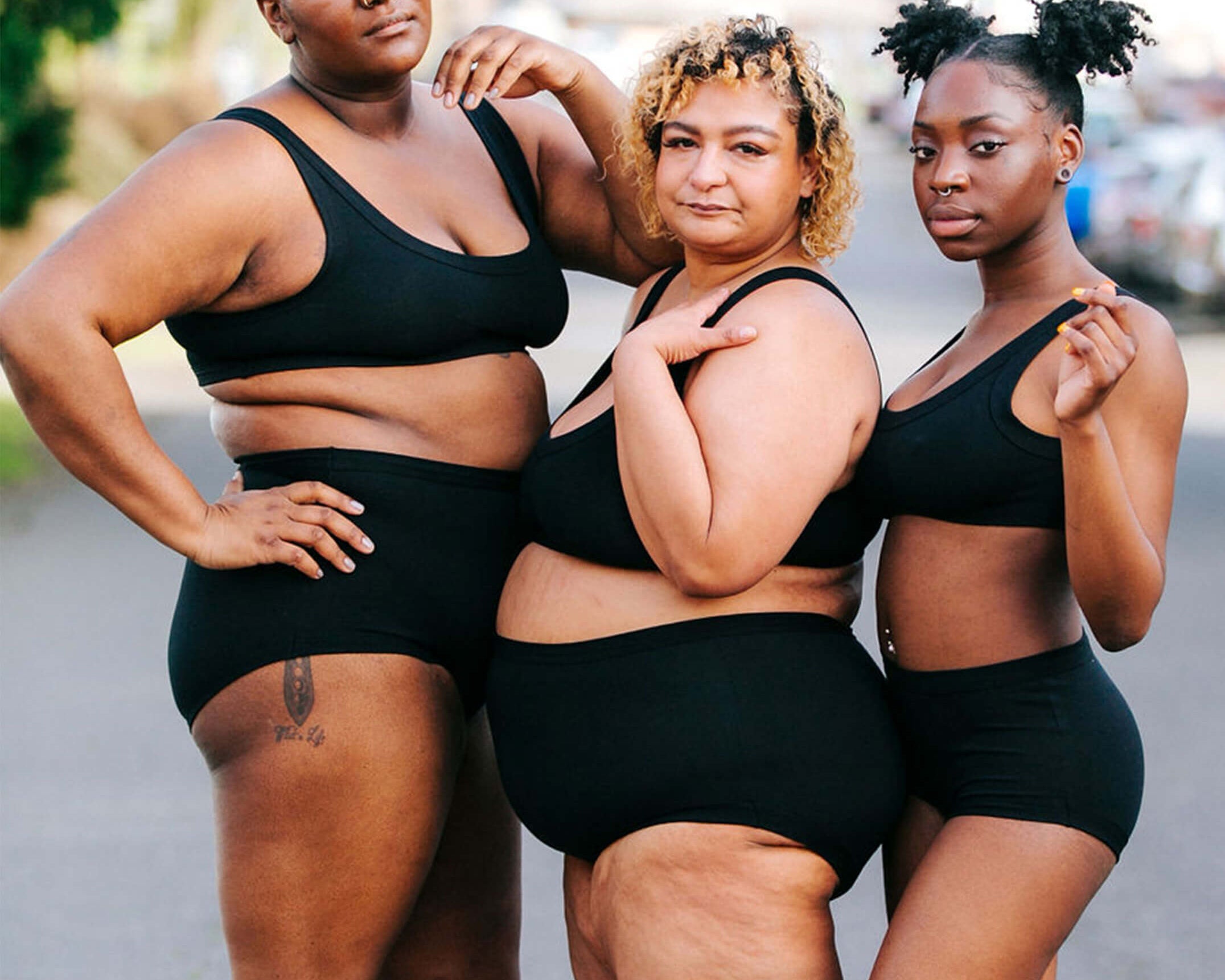 Three models wearing sets of Thunderpants Original style underwear and Bralettes in Plain Black.