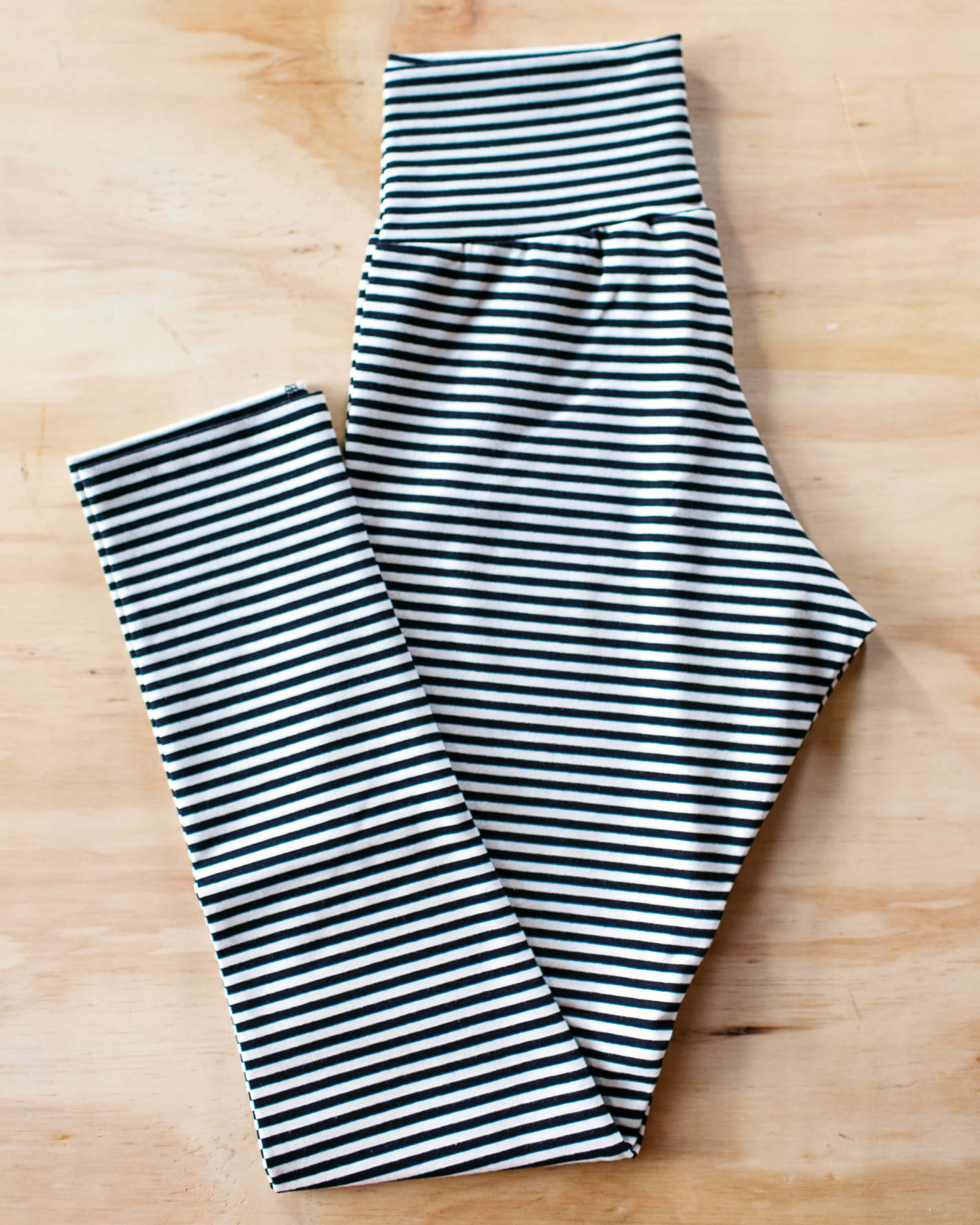 Flat lay of Thunderpants Ankle Length Leggings in Black and White Stripe.