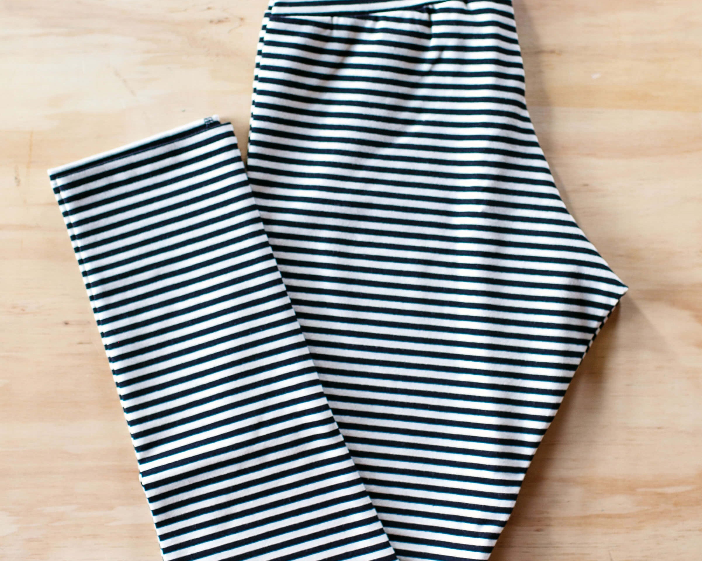 Flat lay of Thunderpants Ankle Length Leggings in Black and White Stripe.