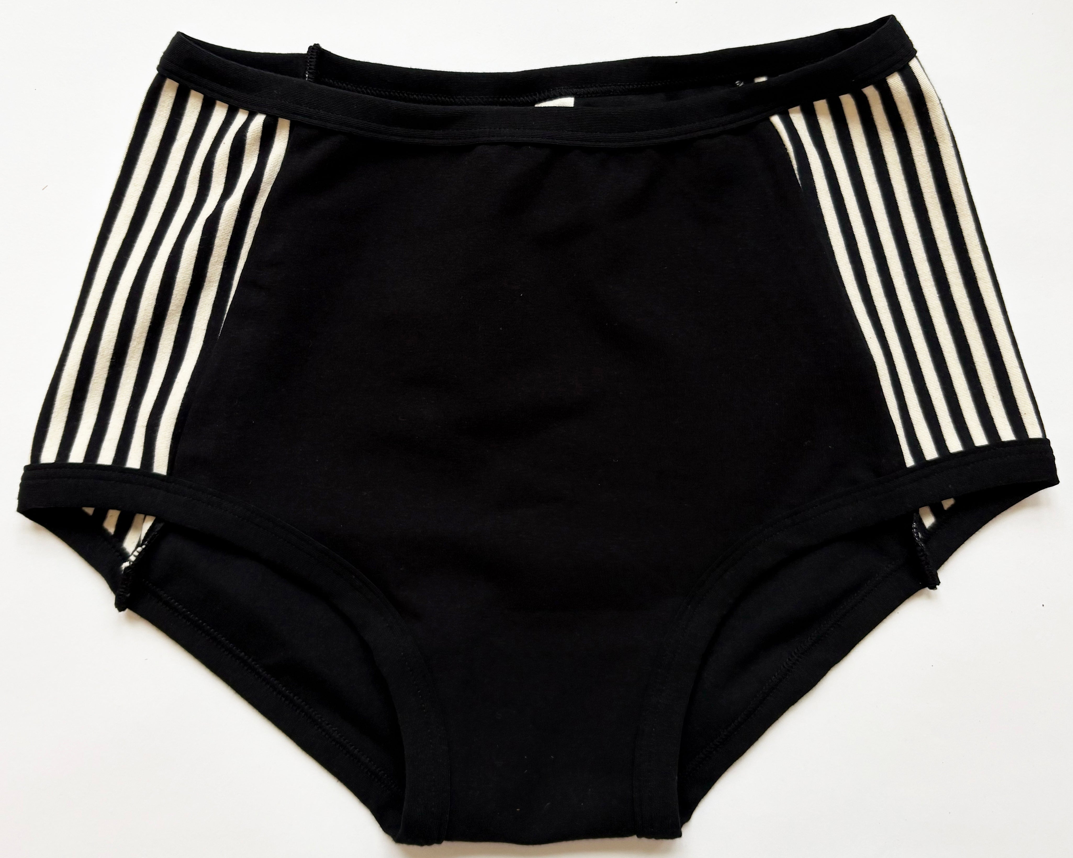 Flat lay of Thunderpants Original style Panel Pants in Black and White Stripe sides and Black front. 