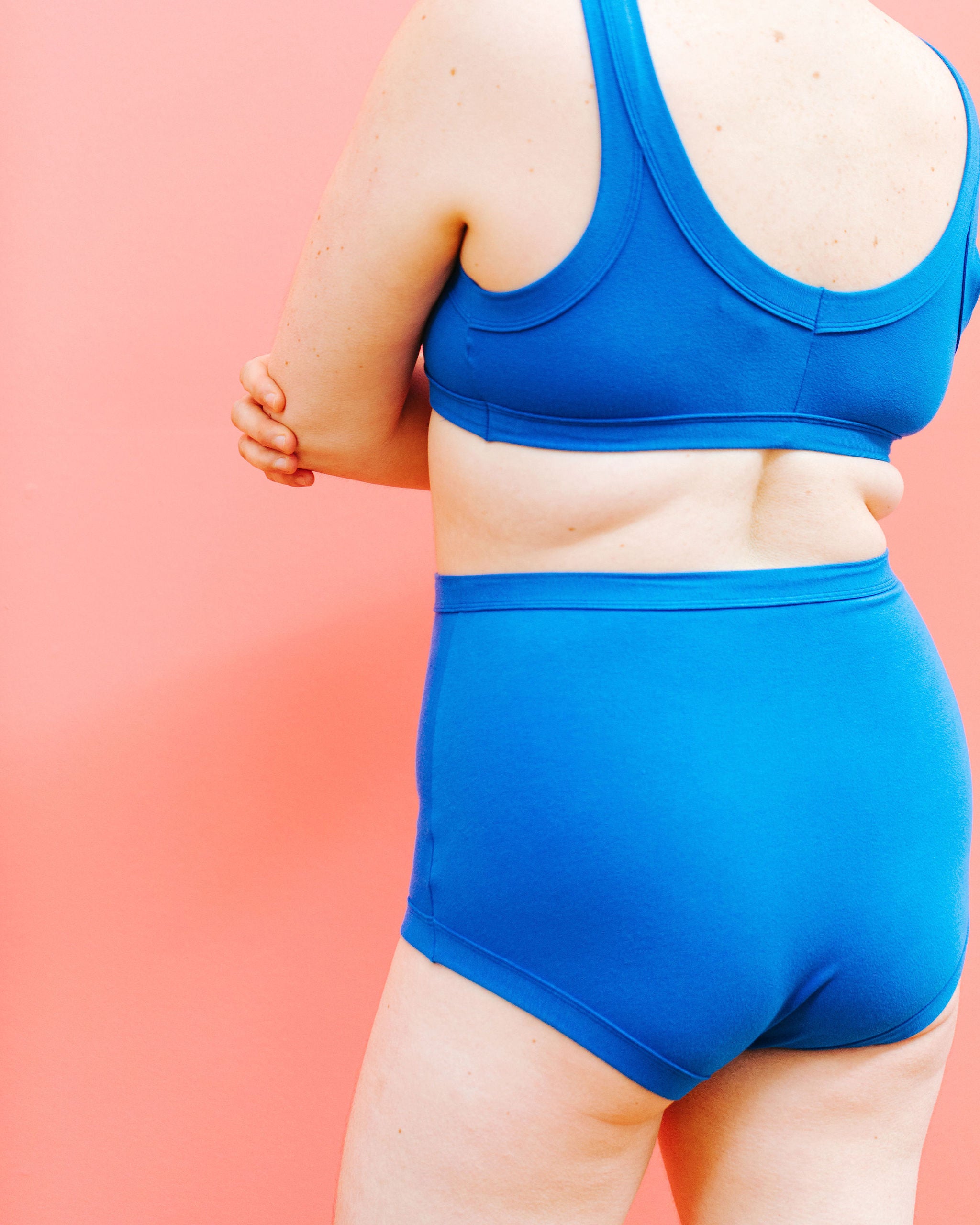 Close up of back of model wearing Thunderpants Sky Rise style underwear and Bralette set in Blueberry Blue.