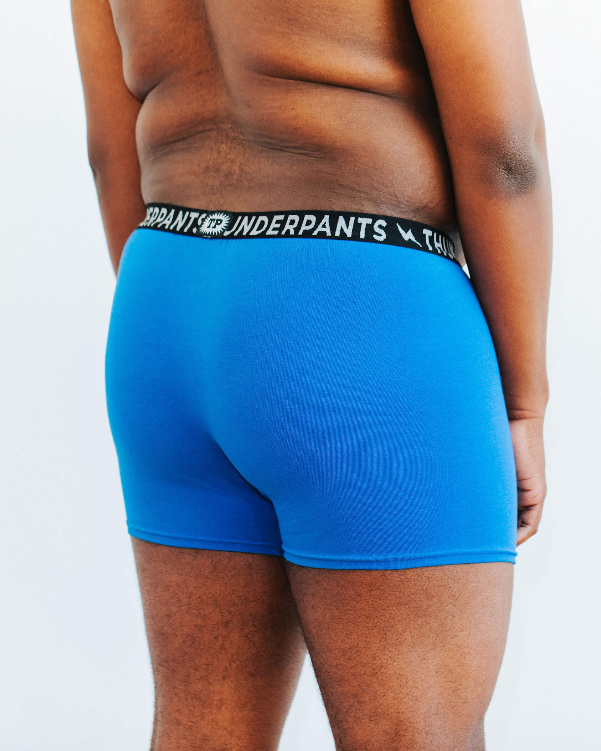Back photo showing Thunderpants Organic Cotton Boxer Brief style underwear in Blueberry Blue on a model.