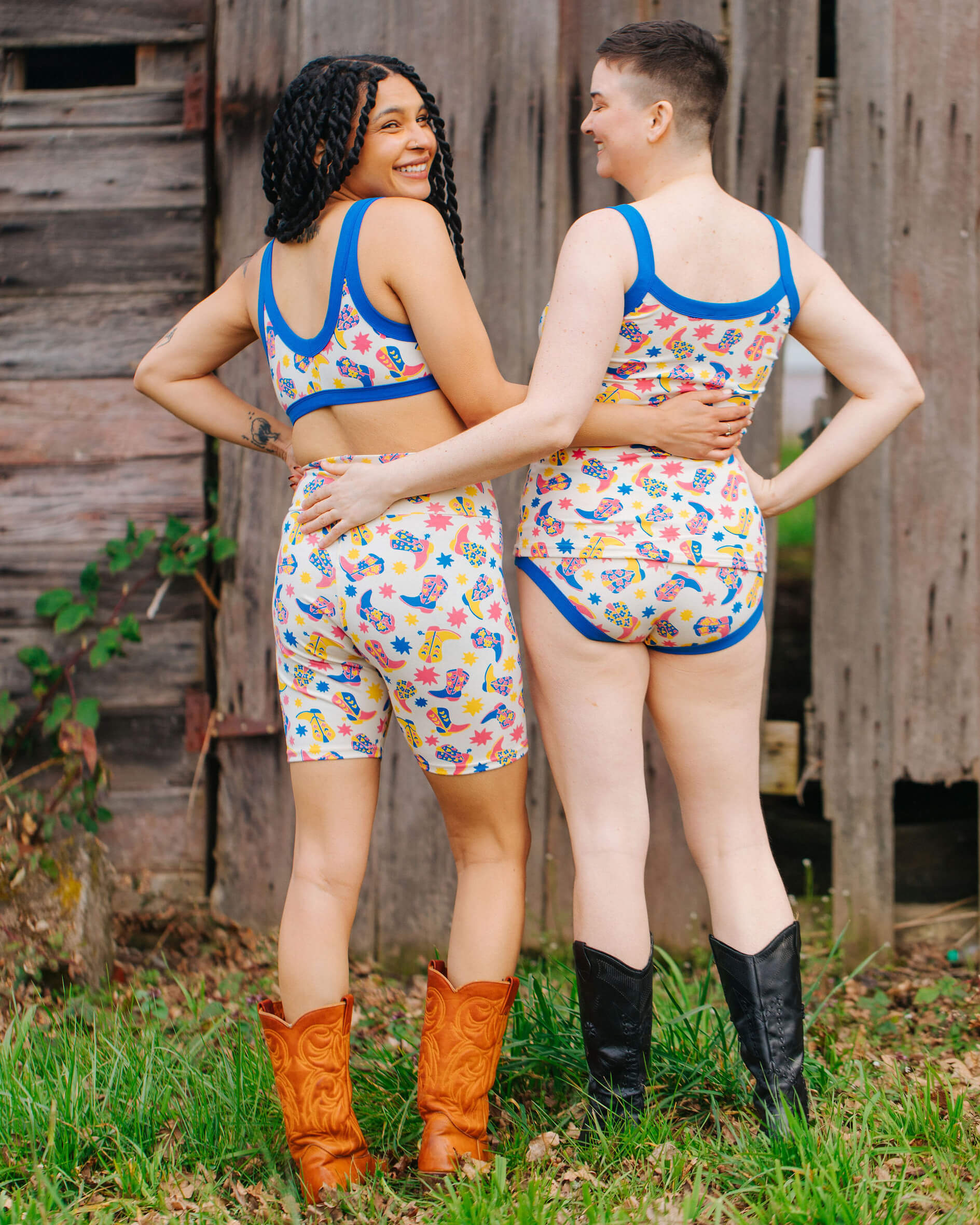 Two models wearing sets of Thunderpants Bike Shorts and Bralette in Boot Scootin' print.