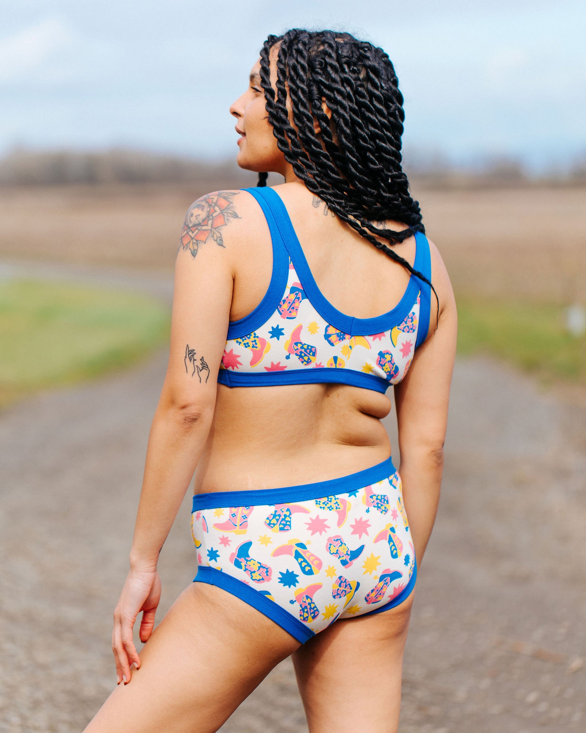 Back of model wearing Thunderpants Hipster style underwear and Bralette in Boot Scootin' - fun boots in pink, yellow, and blue.
