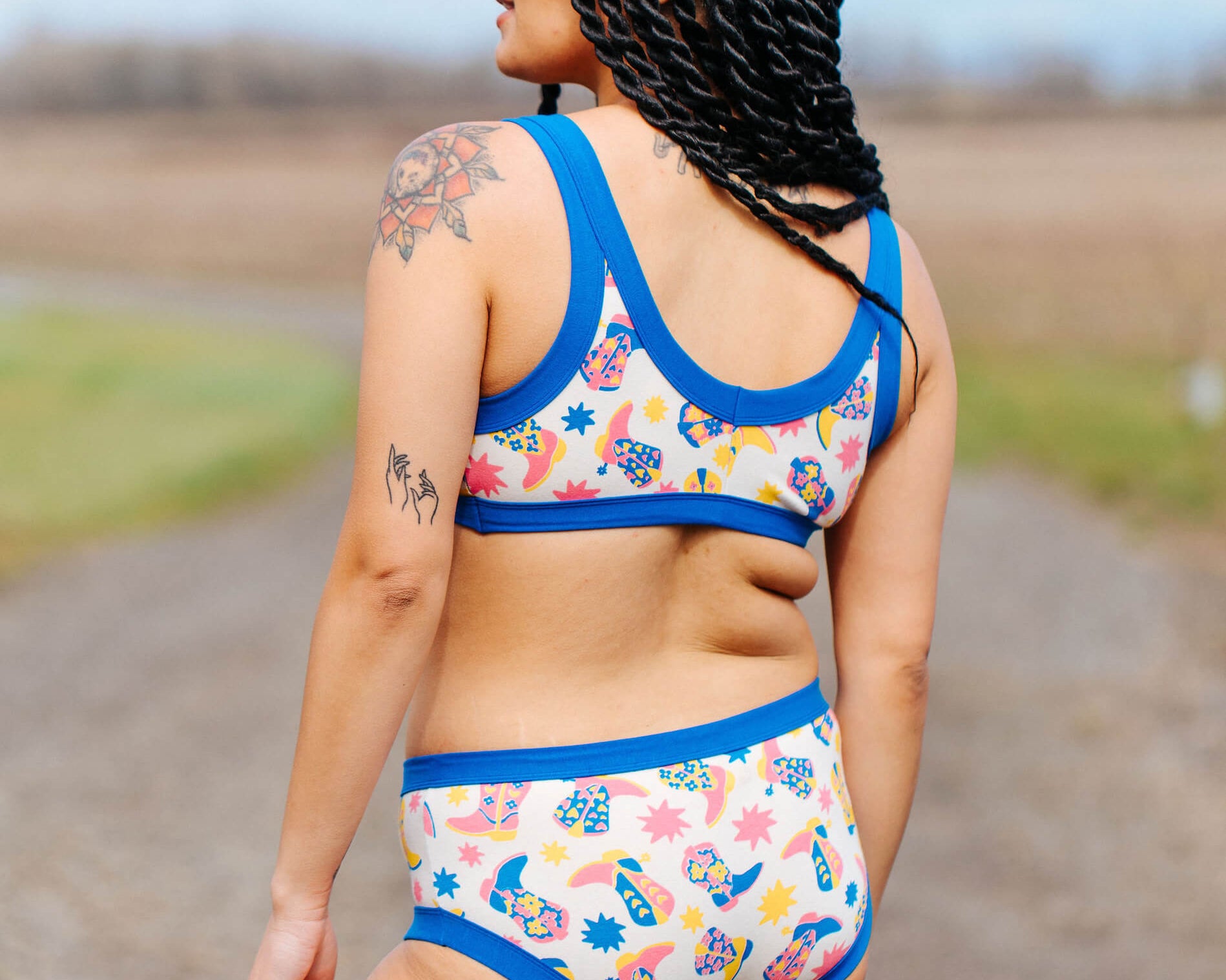 Back of model wearing a set of Thunderpants Hipster style underwear and Bralette in Boot Scootin' print.