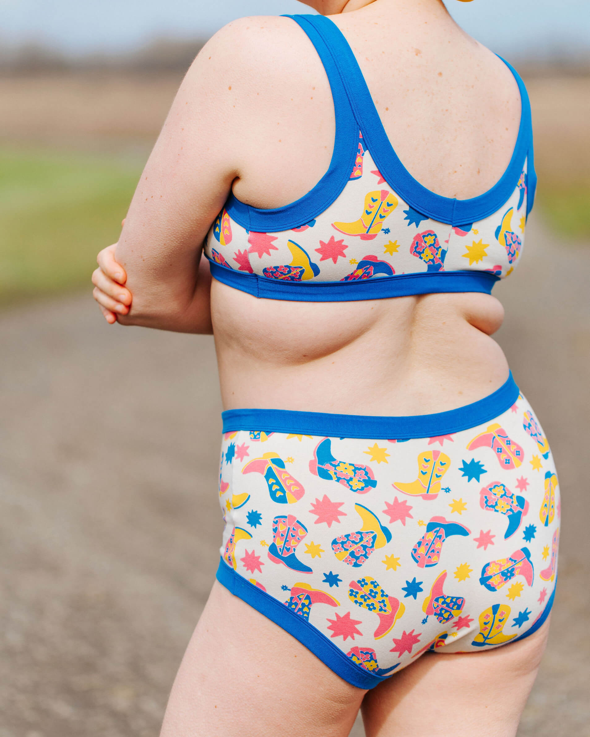 Close up of model wearing a set of Thunderpants Original style underwear and Bralette in Boot Scootin' print.