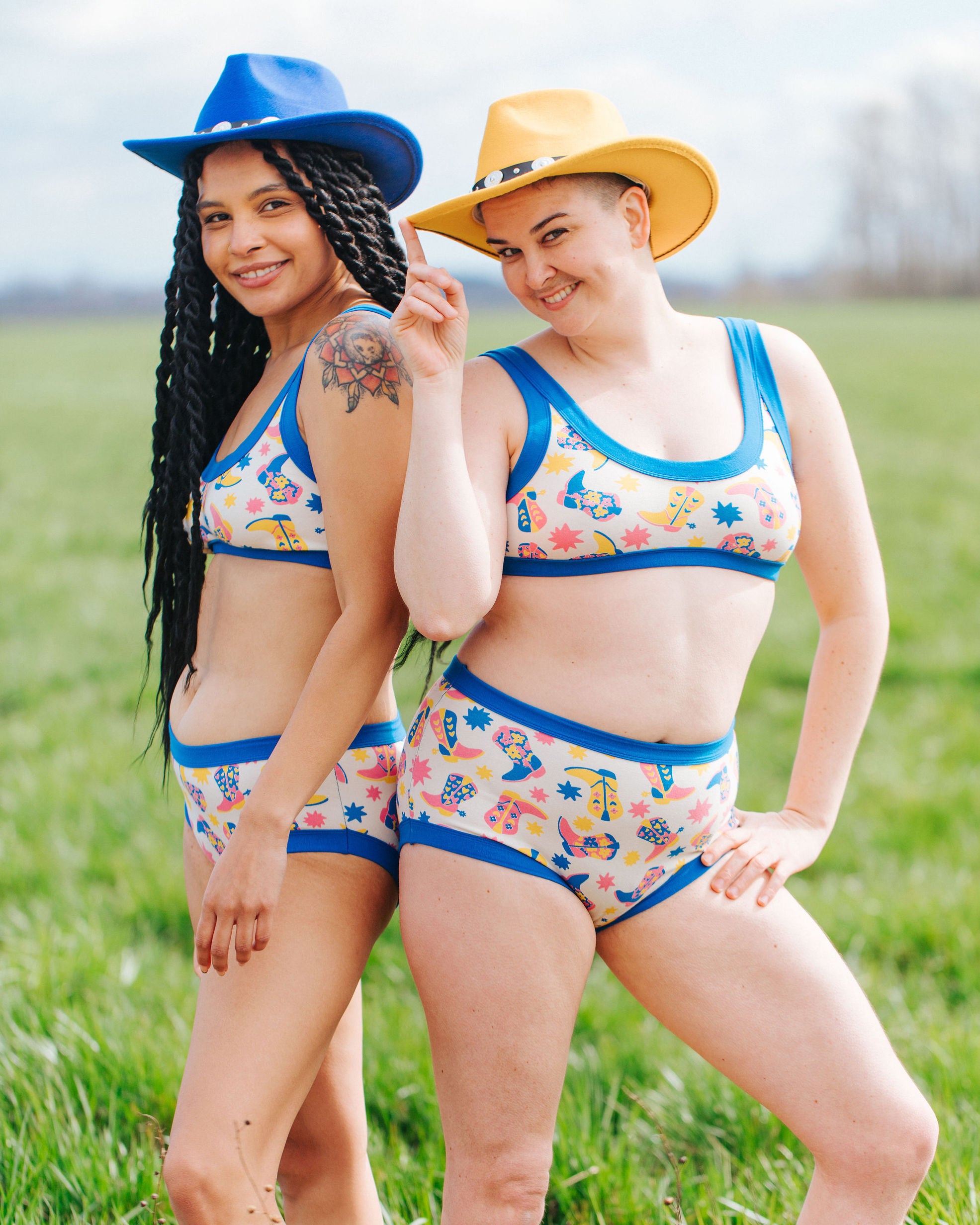 Two models wearing Thunderpants sets in Boot Scootin' - fun boots in pink, yellow, and blue.