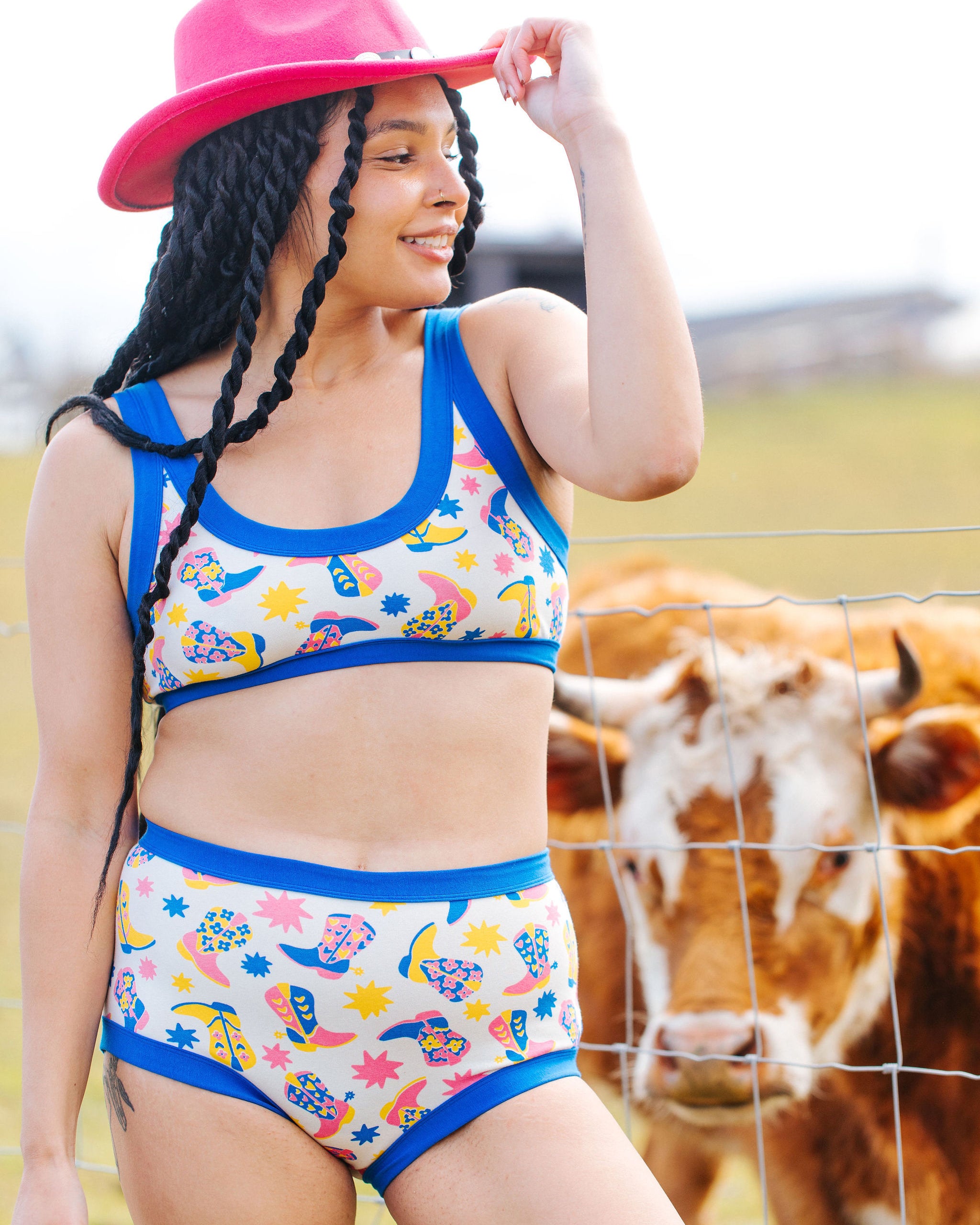 Model wearing Thunderpants Original style underwear and Bralette in Boot Scootin' - fun boots in pink, yellow, and blue.