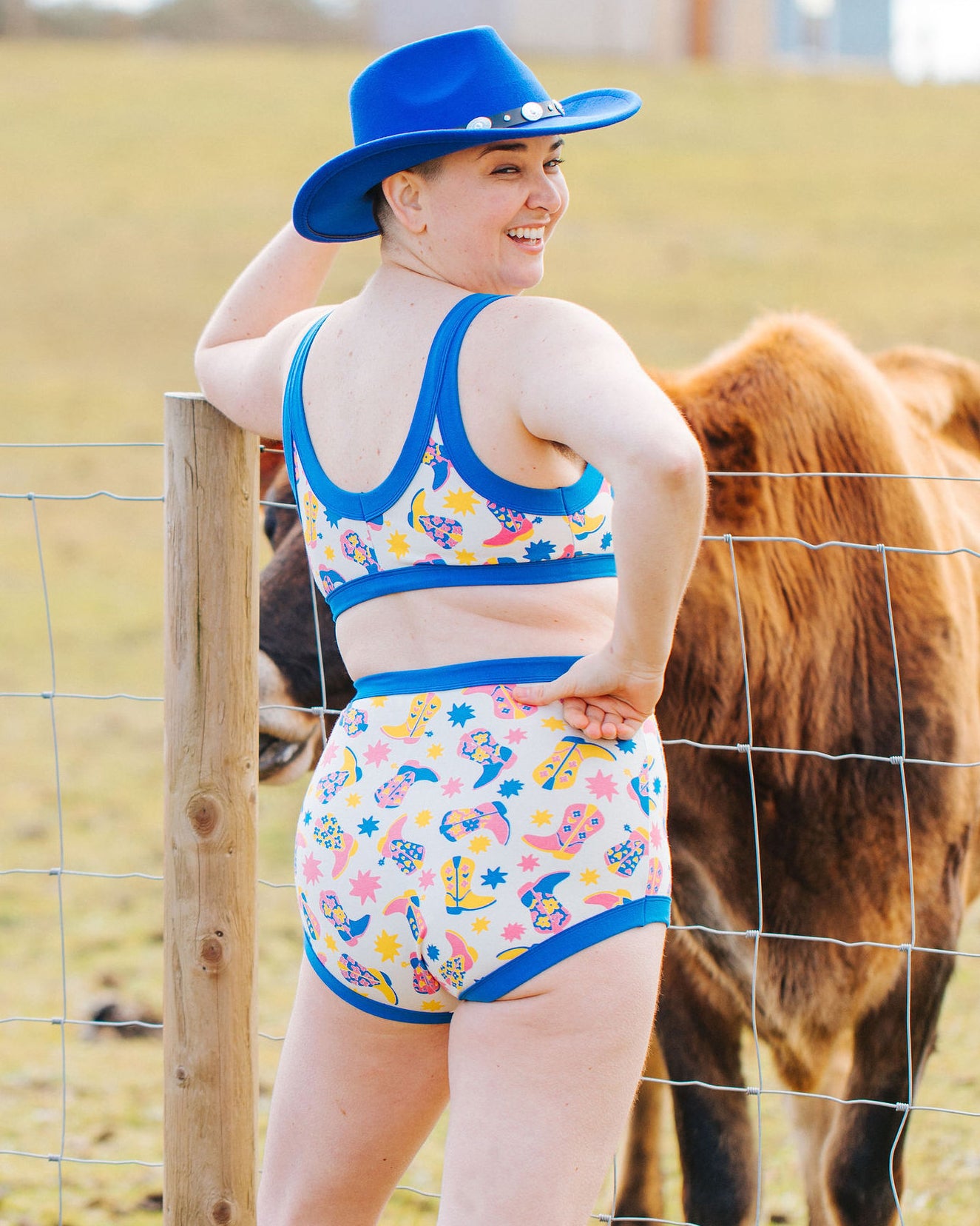 Back of model wearing Thunderpants Sky Rise style underwear and Bralette in Boot Scootin' - fun boots in pink, yellow, and blue.