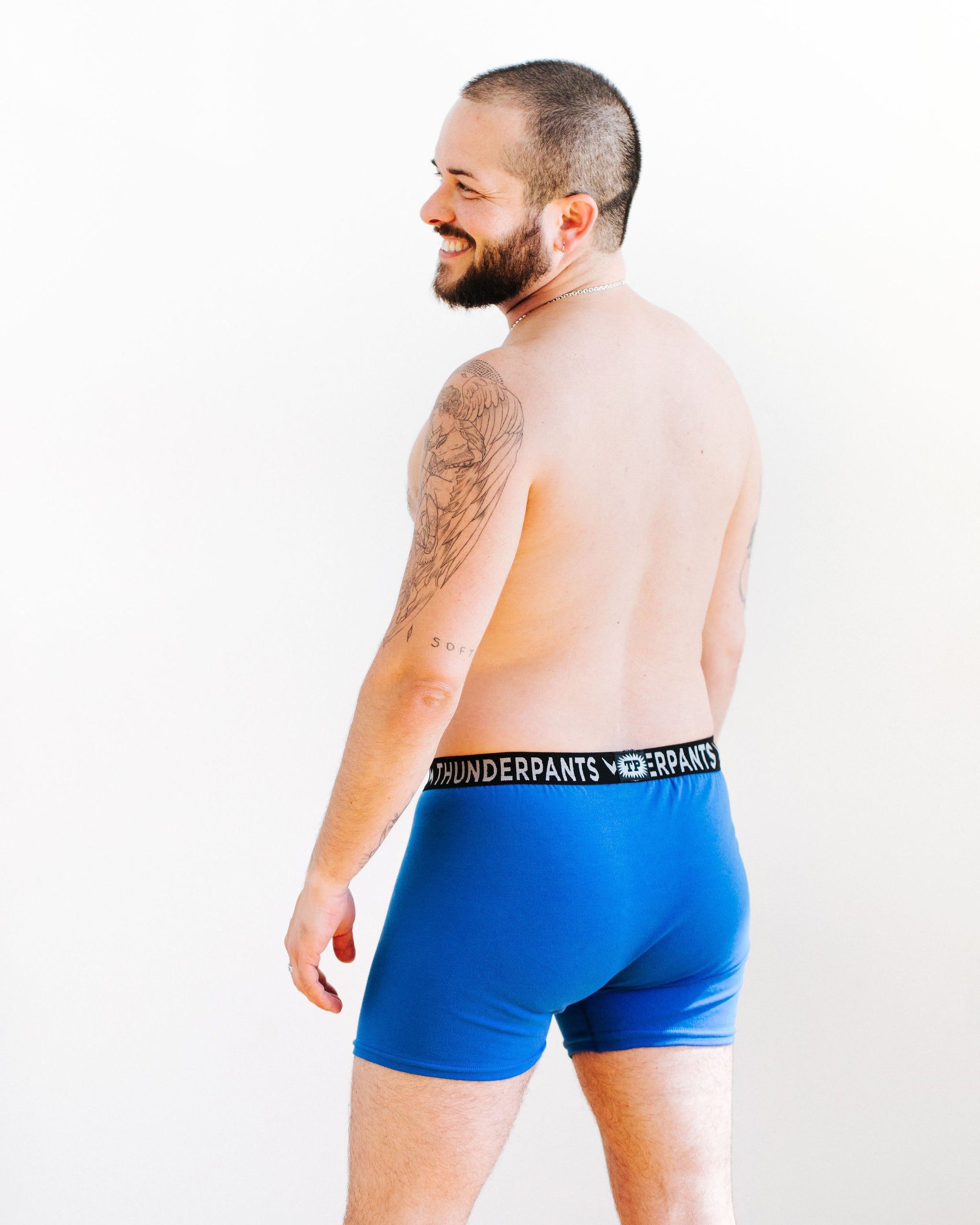 Back of model wearing Thunderpants Boxer Brief style underwear in Blueberry Blue.