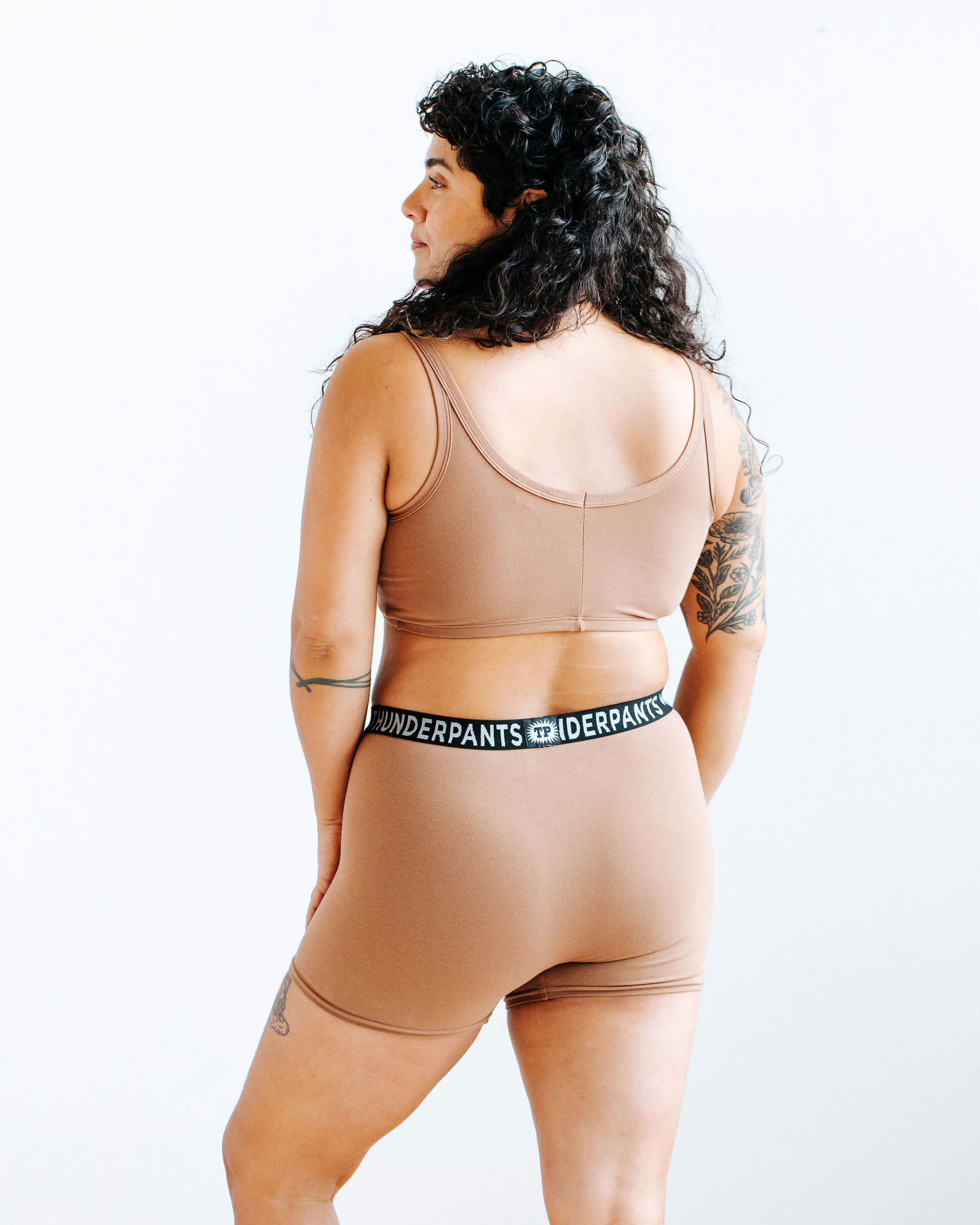 Model wearing Thunderpants Boxer Brief style underwear and Longline Bra in Hazelnut color.