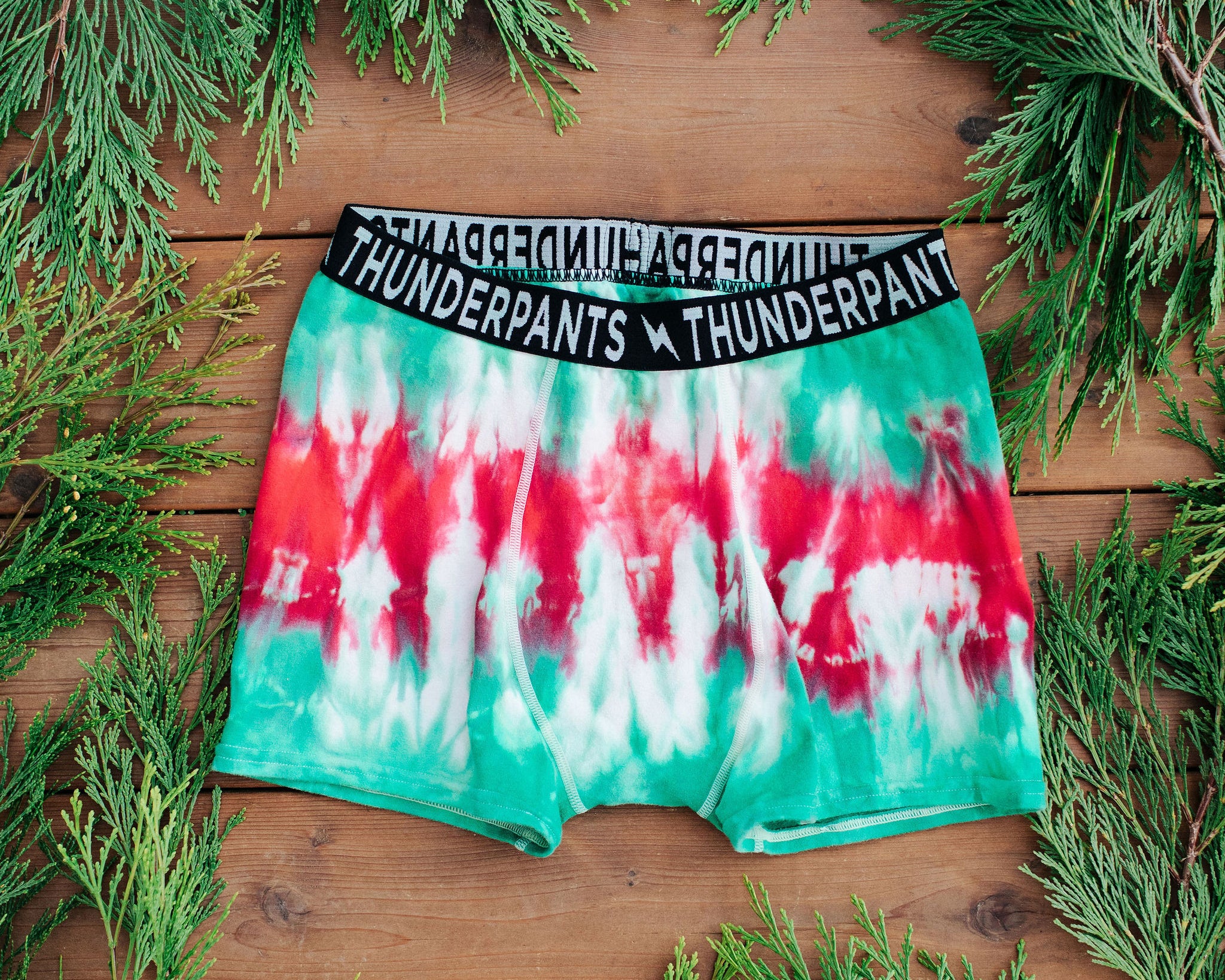 Drawing of Thunderpants Boxer Brief style underwear in Holiday Dye - red and green tie dye with green binding. 