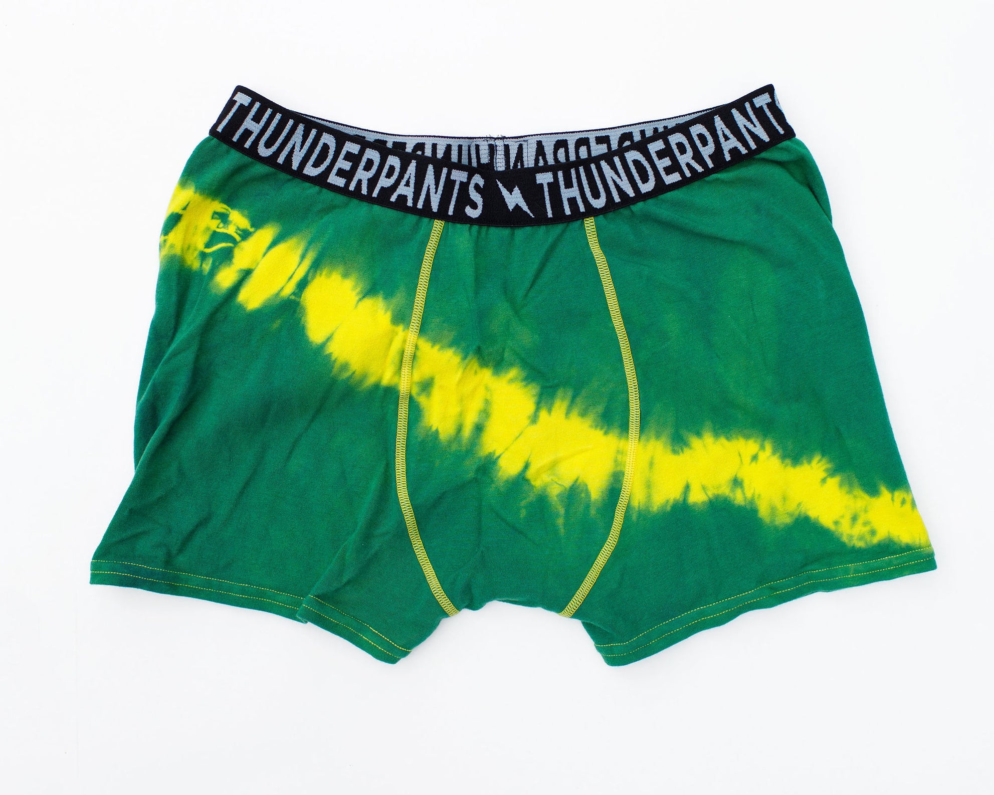 Flat lay of Thunderpants Boxer Brief style underwear in Lightning Bolt hand dye - green/blue with yellow stripe.