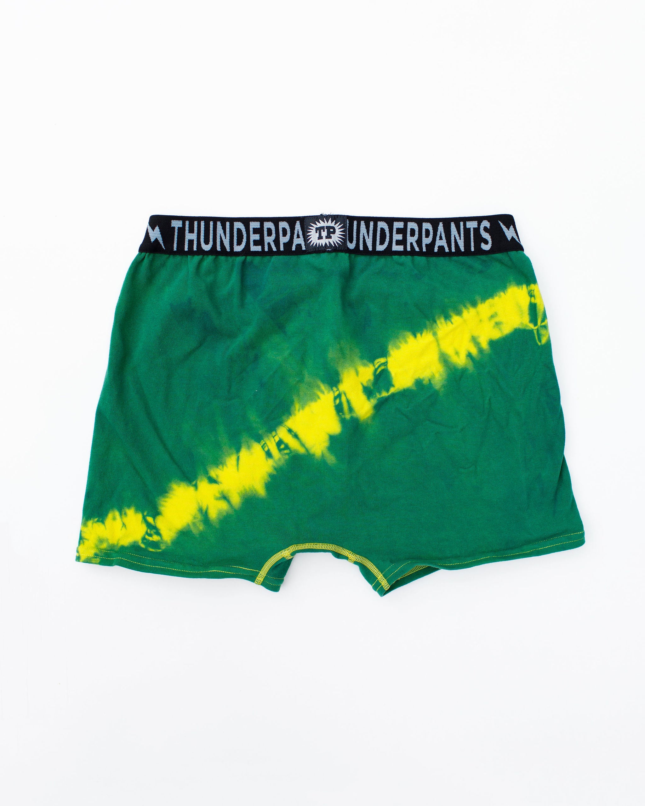 Flat lay of Thunderpants Boxer Brief style underwear in Lightning Bolt hand dye - green/blue with yellow stripe.