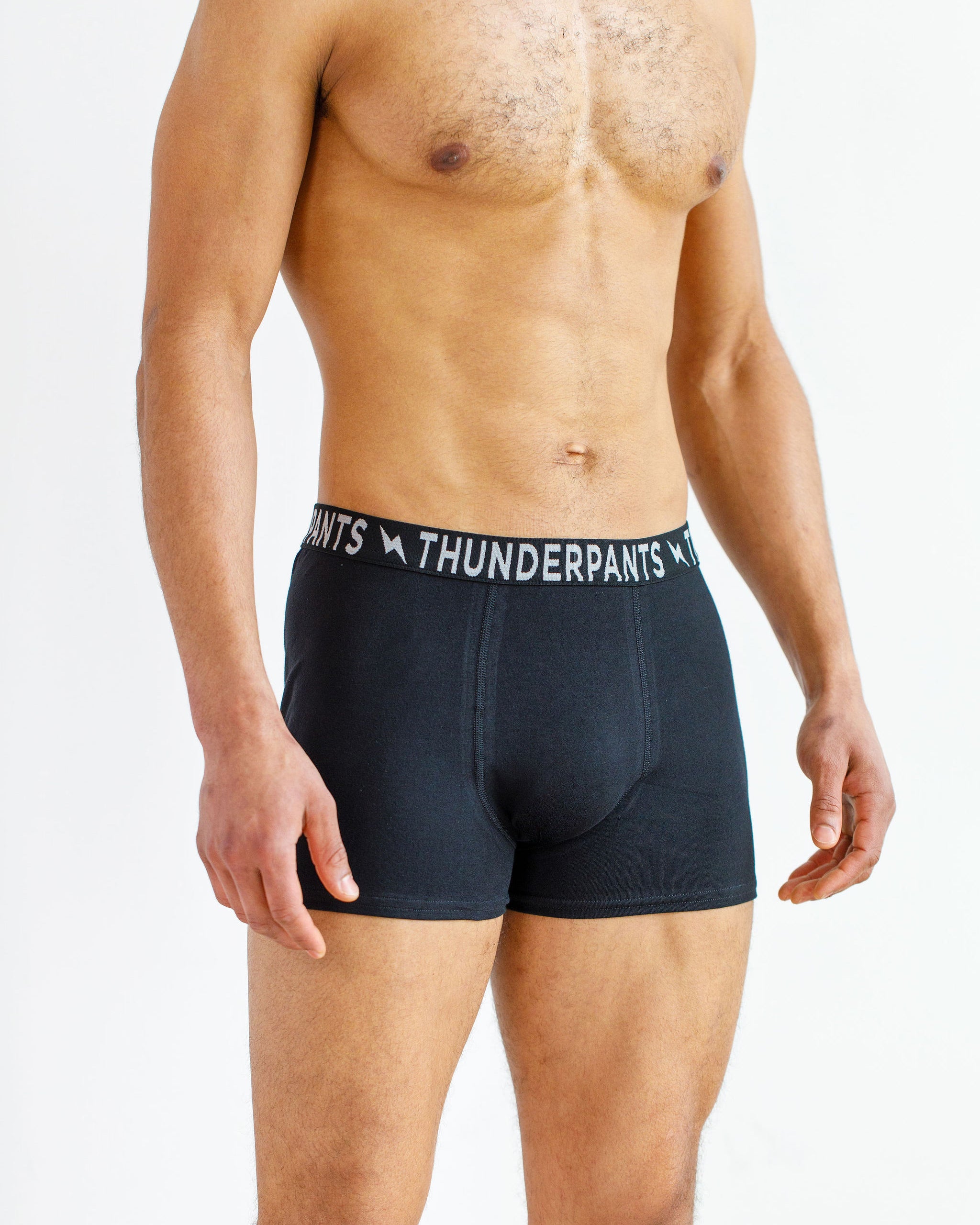 Male model wearing Thunderpants organic cotton Boxer Brief style underwear in Plain Black.
