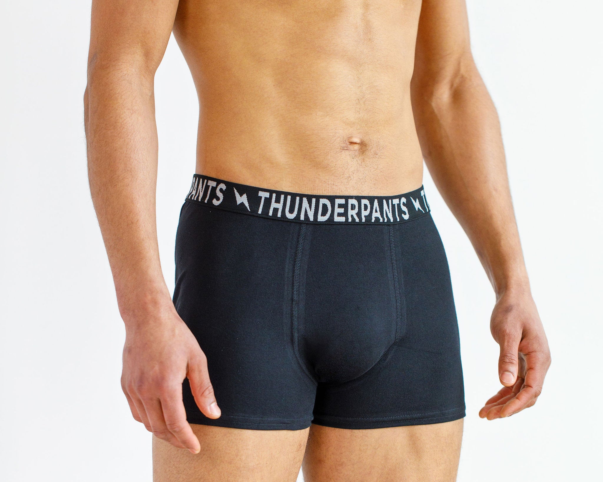 Male model wearing Thunderpants organic cotton Boxer Brief style underwear in Plain Black.