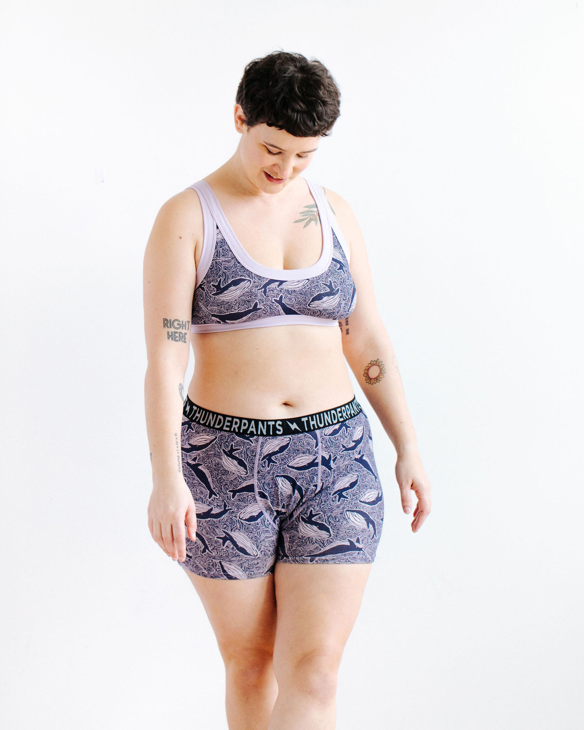 Model wearing Thunderpants Boxer Brief style underwear and Bralette in Whale, Whale, Whale print - indigo whales on lavender.