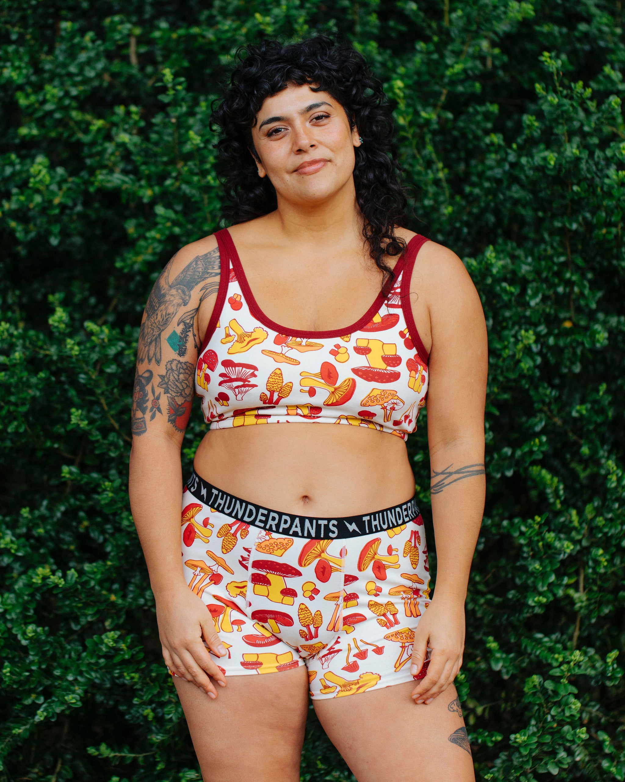 Model wearing Thunderpants Boxer Brief style underwear  and Longline Bra in Whadda Fungi - red, yellow, and orange mushroom print.