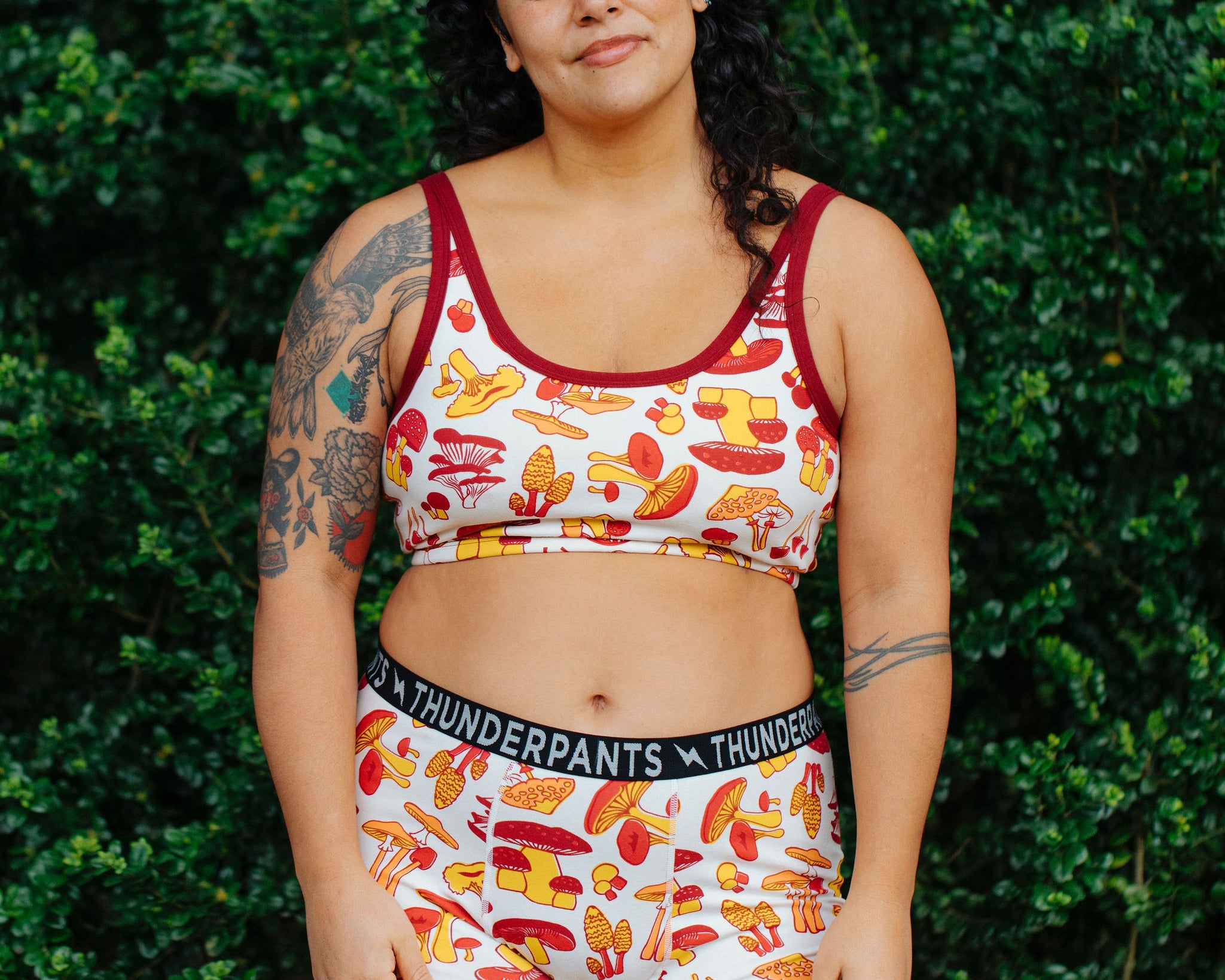 Model wearing Thunderpants Boxer Brief style underwear  and Longline Bra in Whadda Fungi - red, yellow, and orange mushroom print.