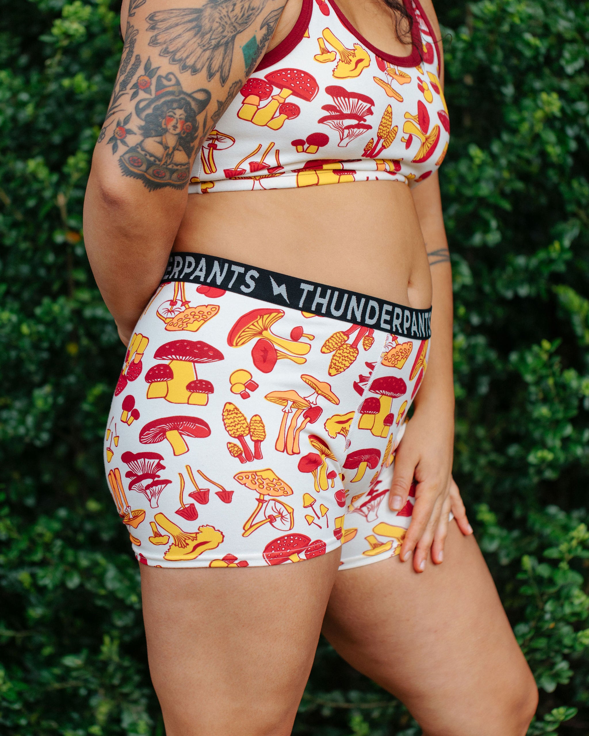 Model wearing Thunderpants Boxer Brief style underwear  and Longline Bra in Whadda Fungi - red, yellow, and orange mushroom print.