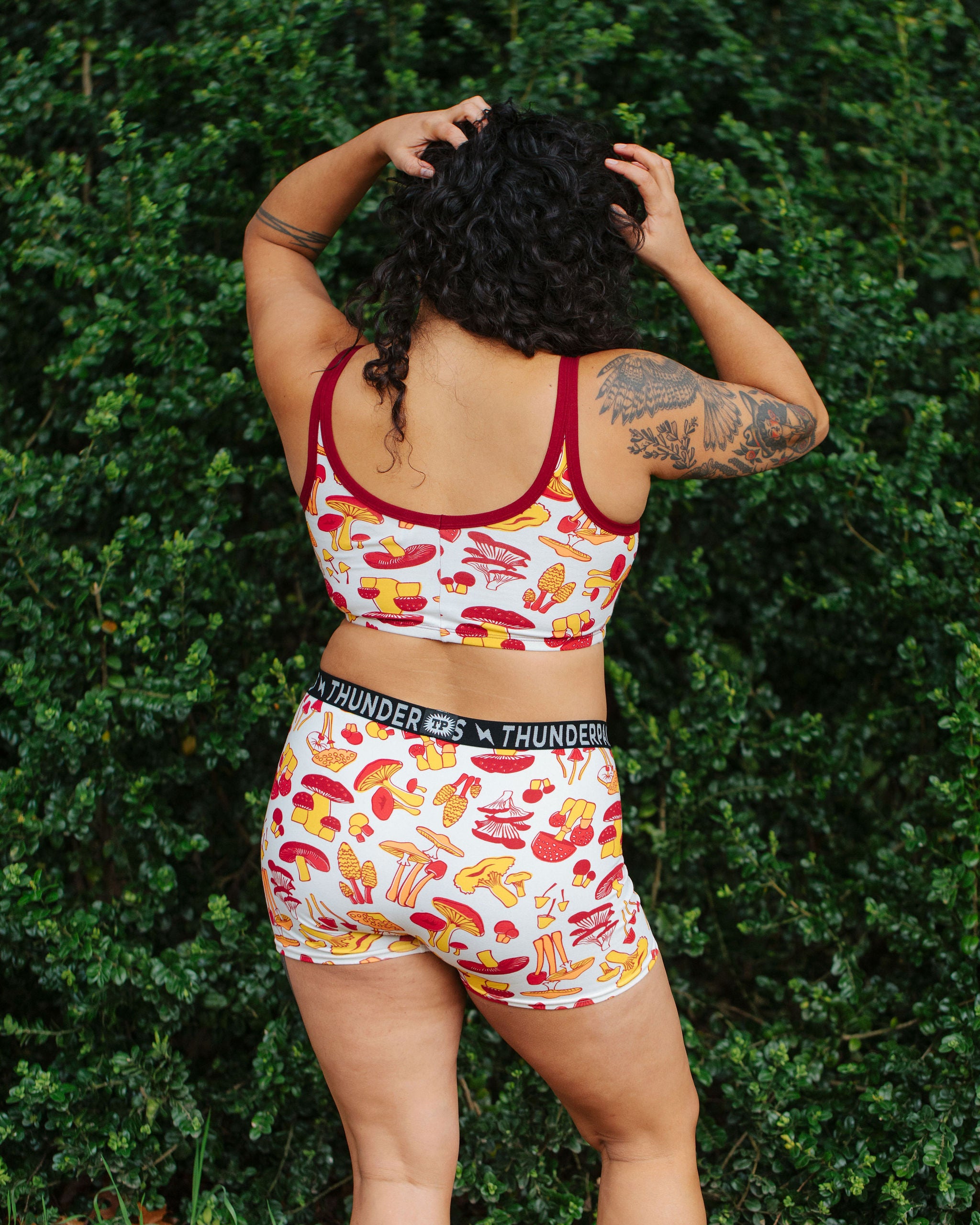 Model wearing Thunderpants Boxer Brief style underwear  and Longline Bra in Whadda Fungi - red, yellow, and orange mushroom print.