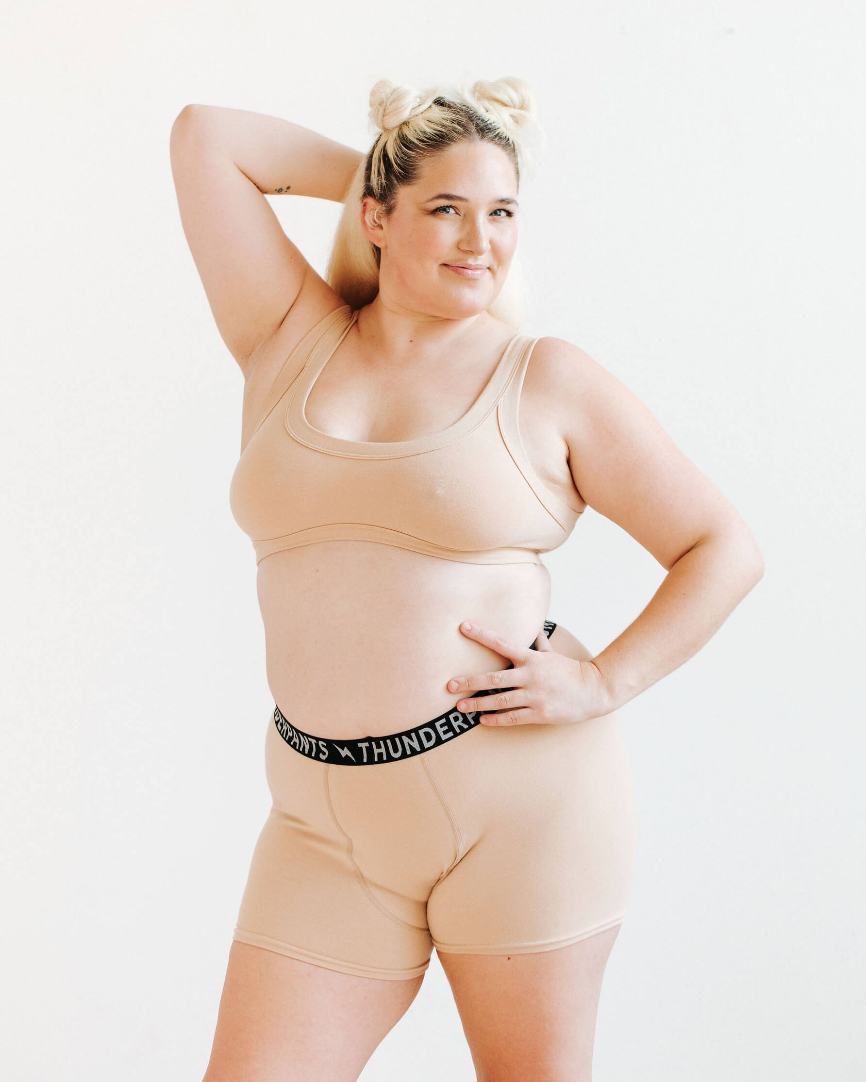 Model wearing Thunderpants Bralette and Boxer Brief in Pine Nut - lighter tan color.