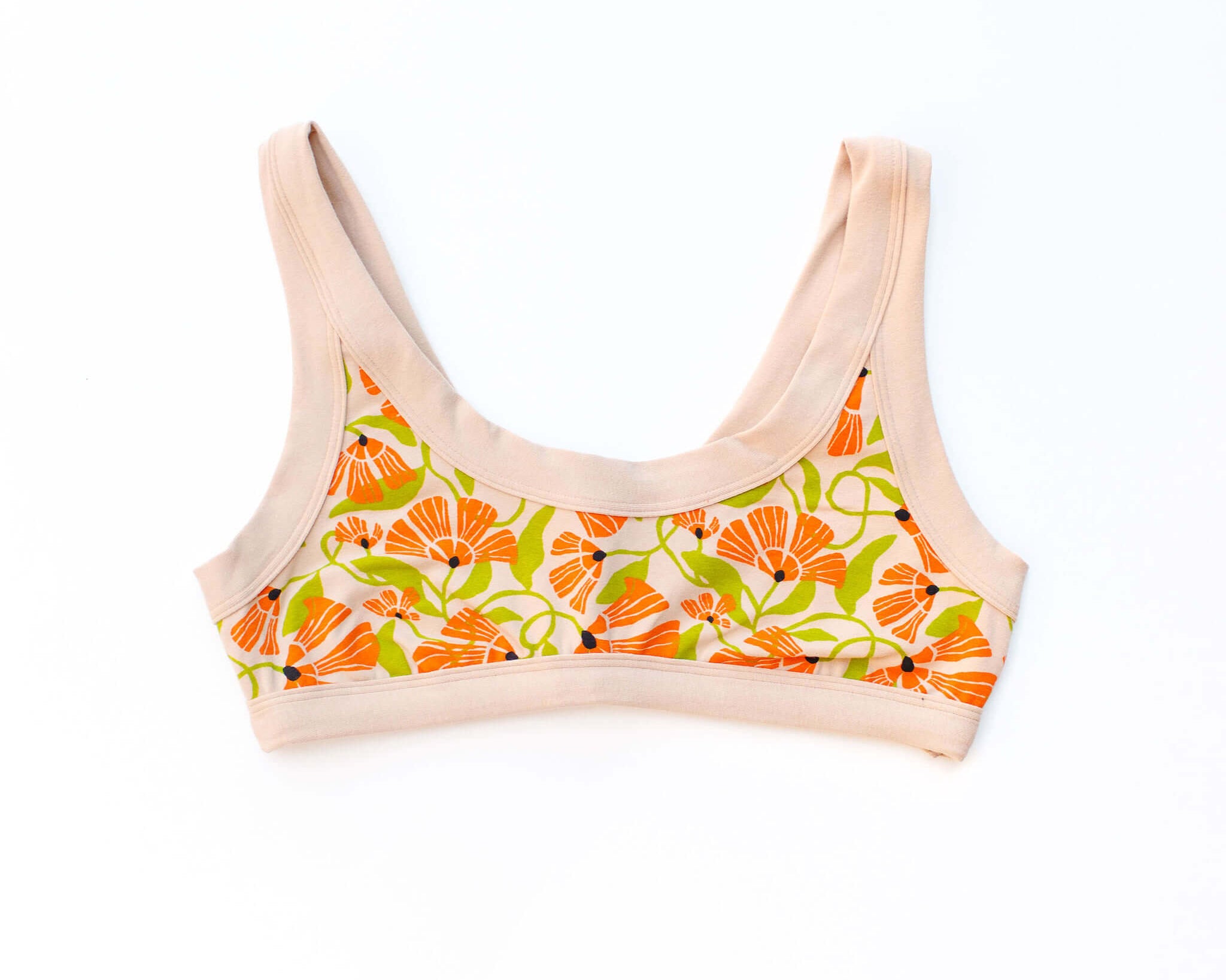 Flat lay of Thunderpants Bralette in Secret Garden print - orange and green flowers on tan.