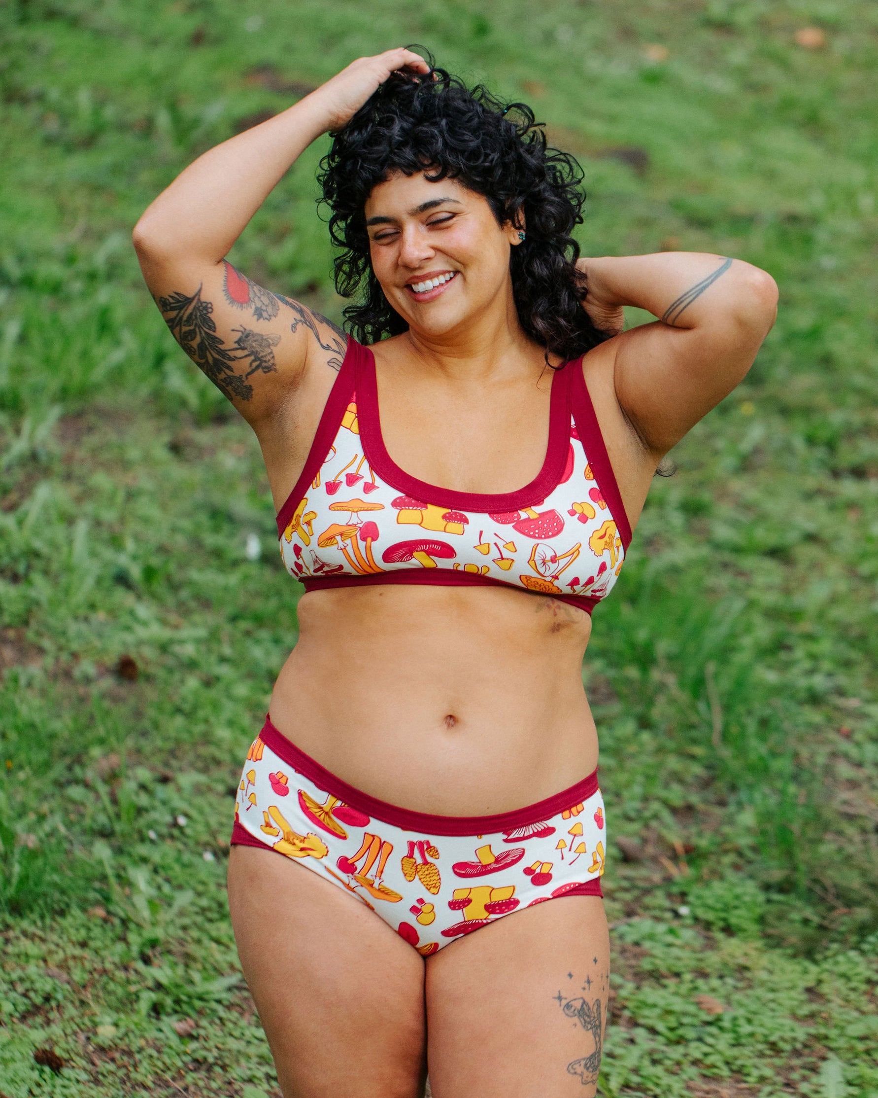 Model wearing Thunderpants Bralette and Hipster style underwear in Whadda Fungi print - red, yellow, and orange mushroom print.