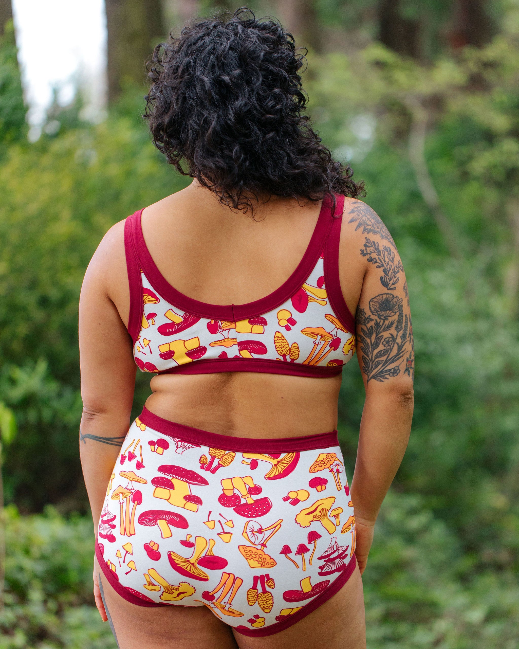 Model wearing Thunderpants Bralette and Sky Rise style underwear in Whadda Fungi print - red, yellow, and orange mushroom print.