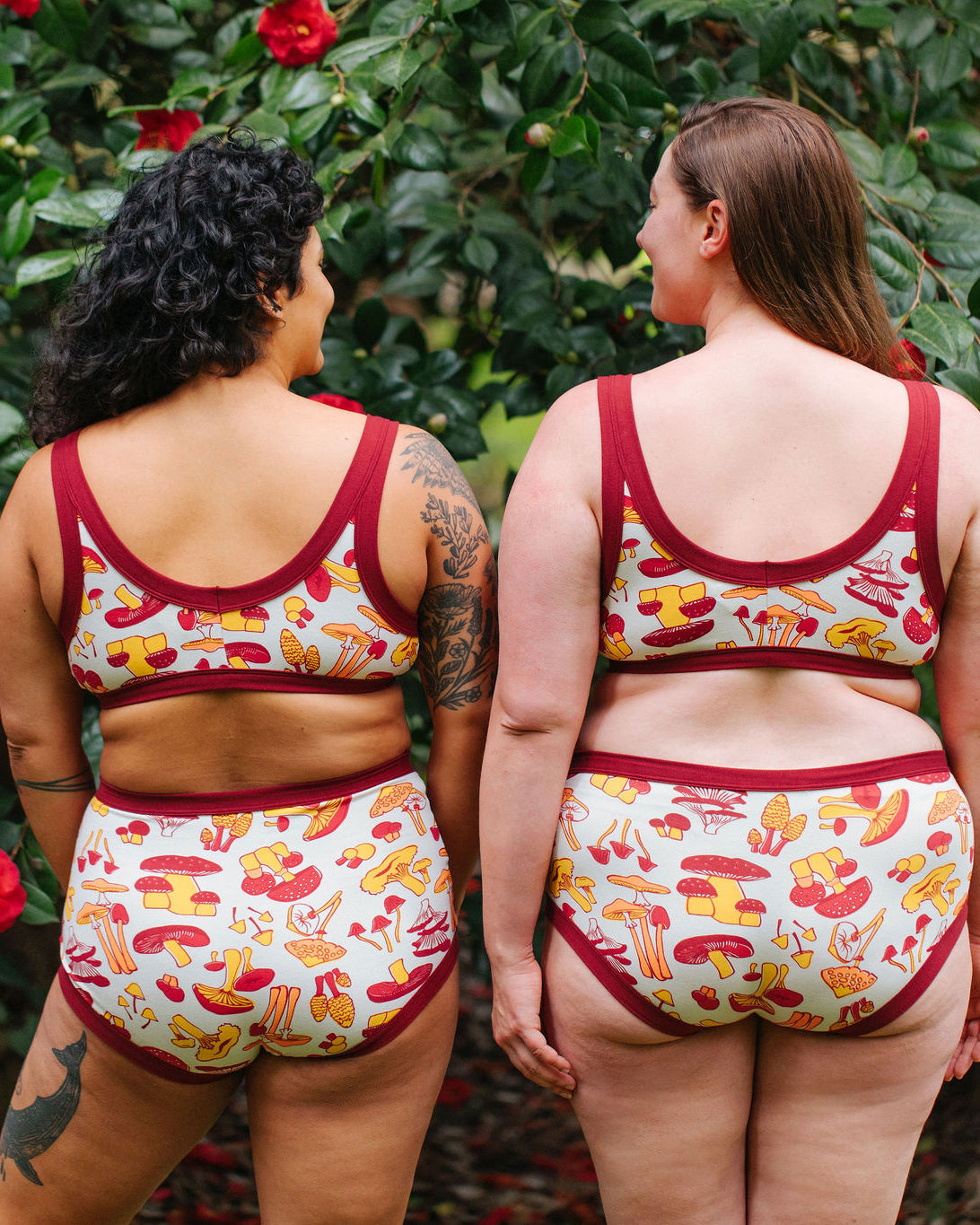 Two models wearing Thunderpants Bralette and underwear in Whadda Fungi print - red, yellow, and orange mushroom print.