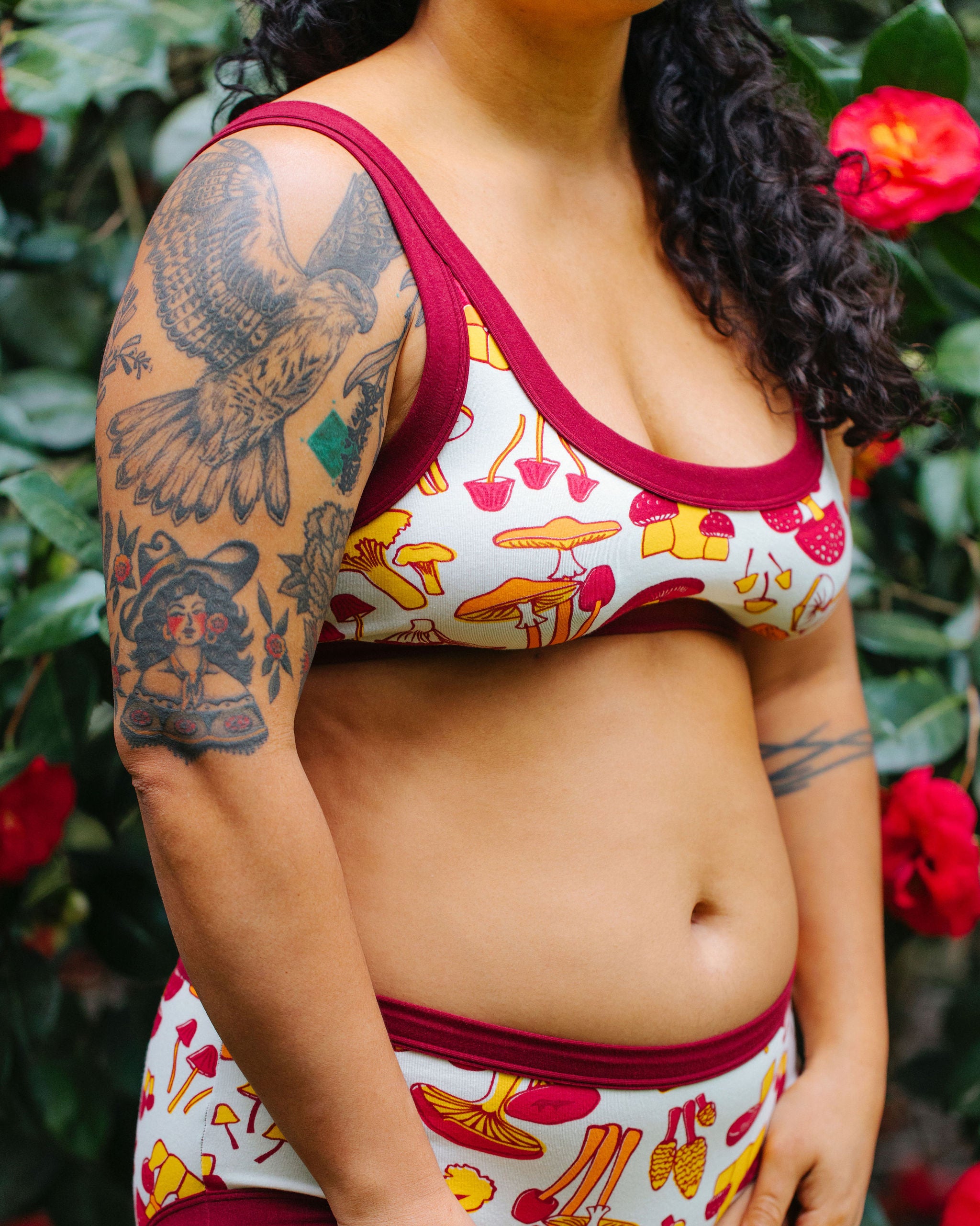 Model wearing Thunderpants Bralette in Whadda Fungi print - red, yellow, and orange mushroom print.
