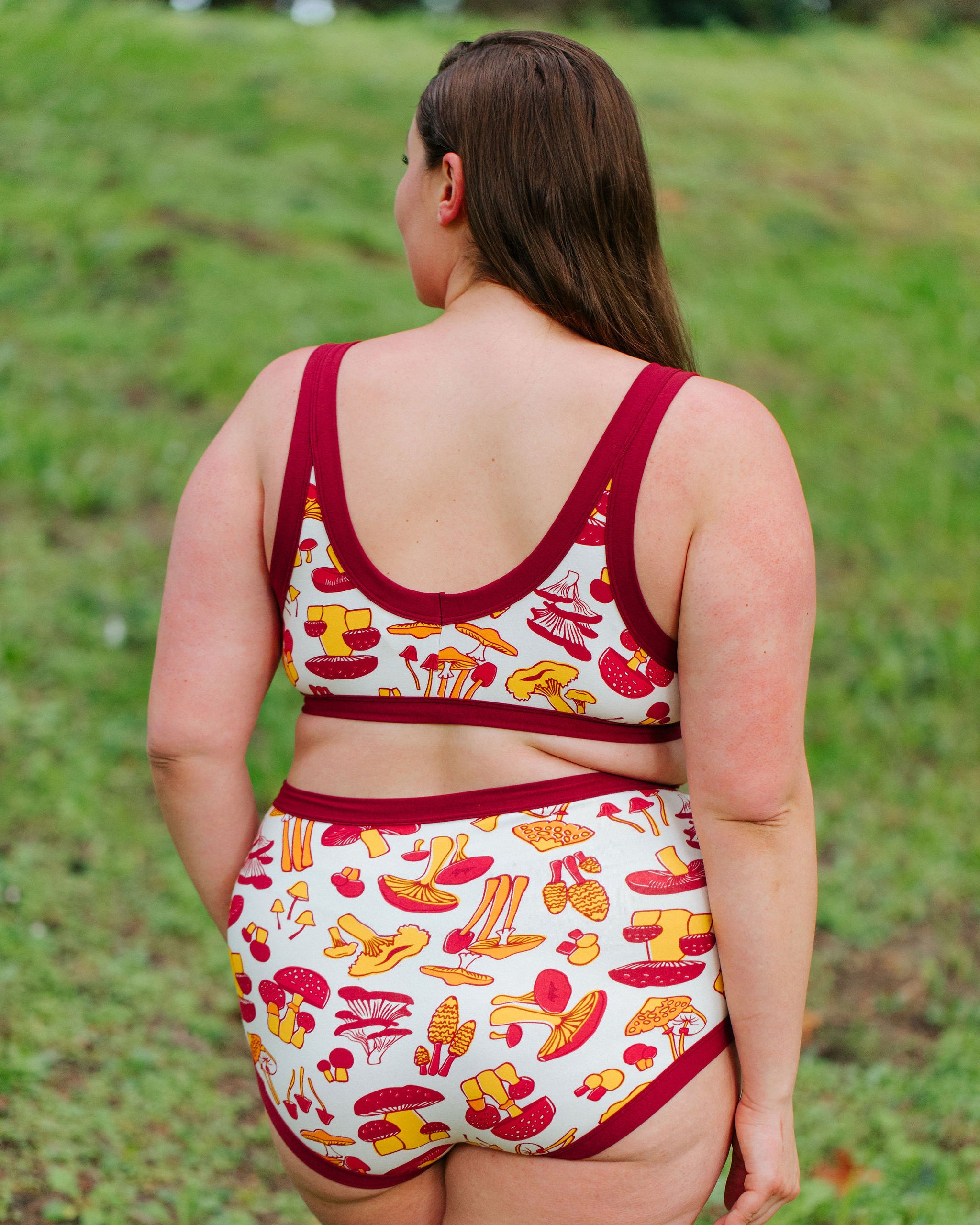 Model wearing Thunderpants Bralette and Sky Rise style underwear in Whadda Fungi print - red, yellow, and orange mushroom print.