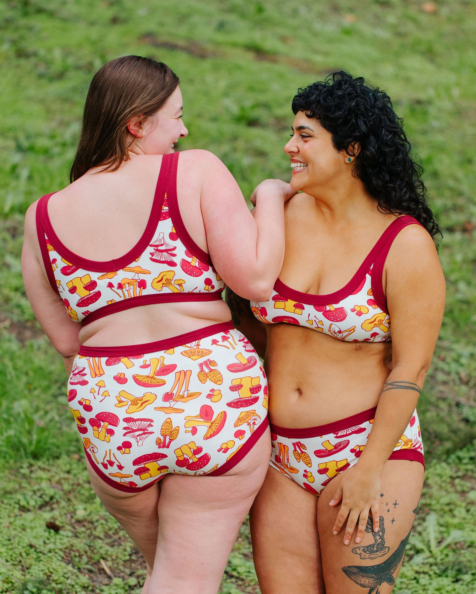 Two models wearing Thunderpants Bralette and underwear in Whadda Fungi print - red, yellow, and orange mushroom print.